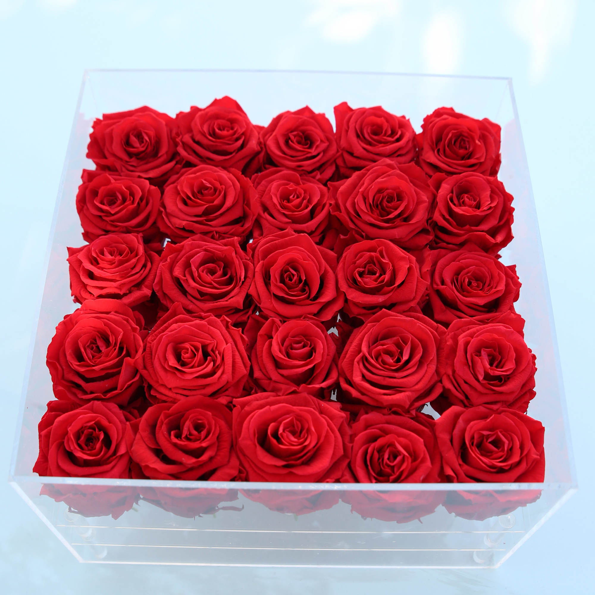 Box of red roses in a clear square container