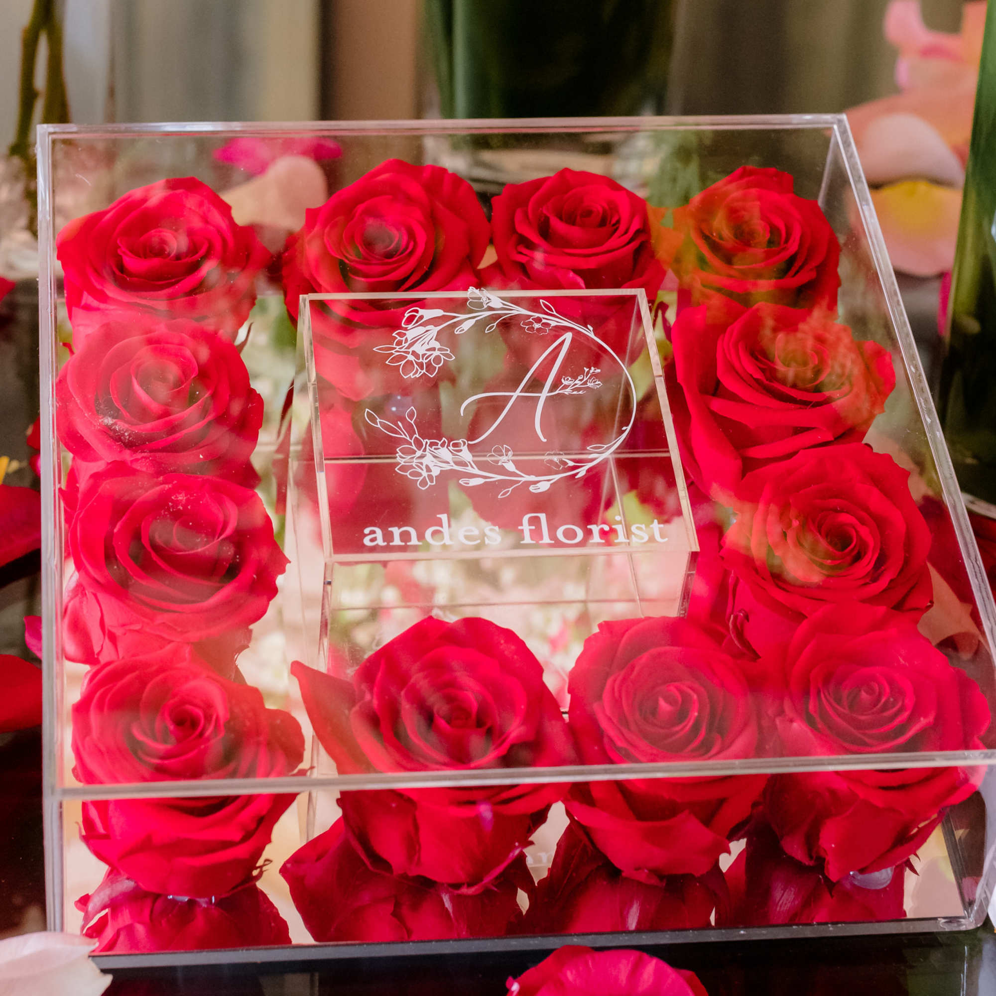 Box of red roses in a clear acrylic case
