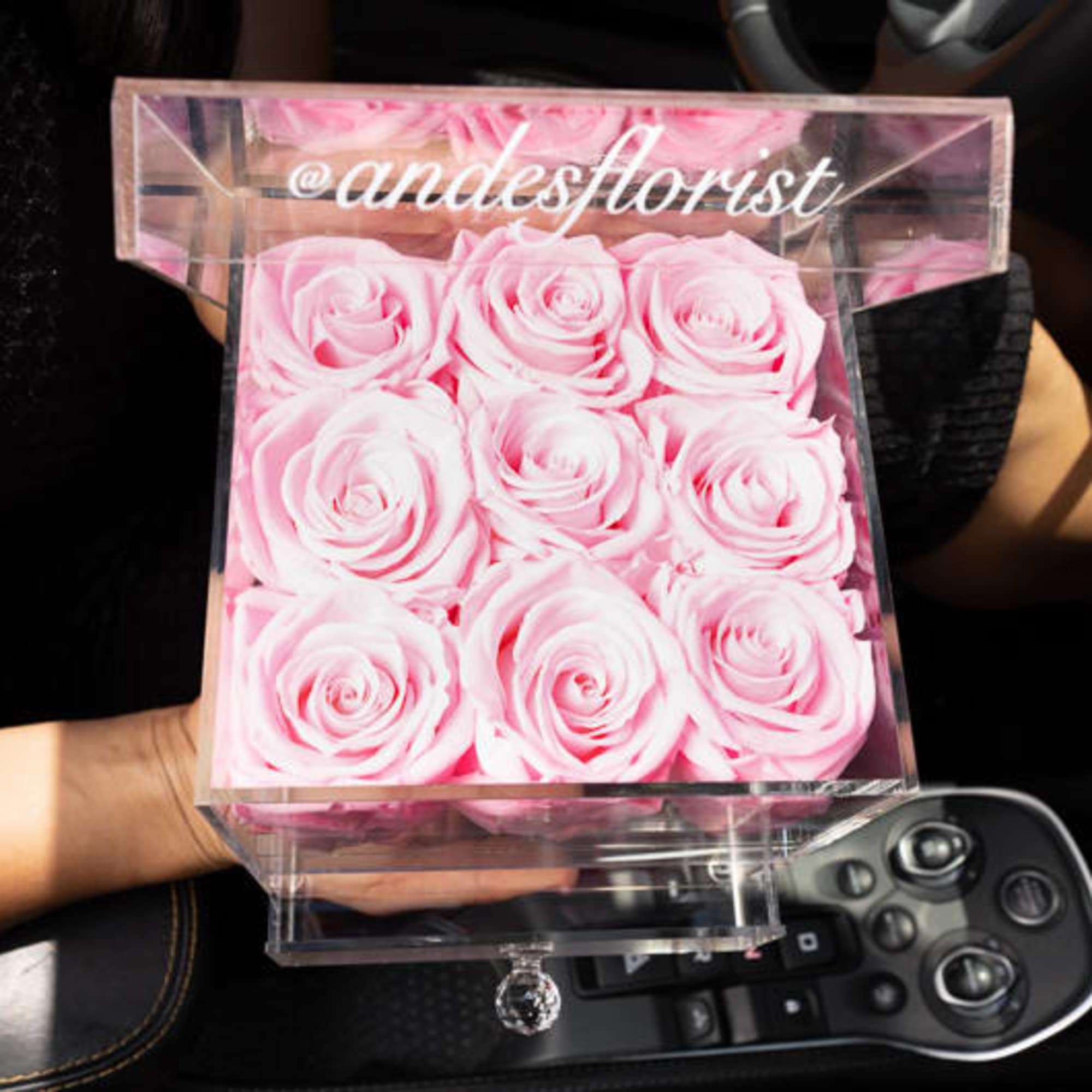 Pink roses arranged in a clear acrylic box