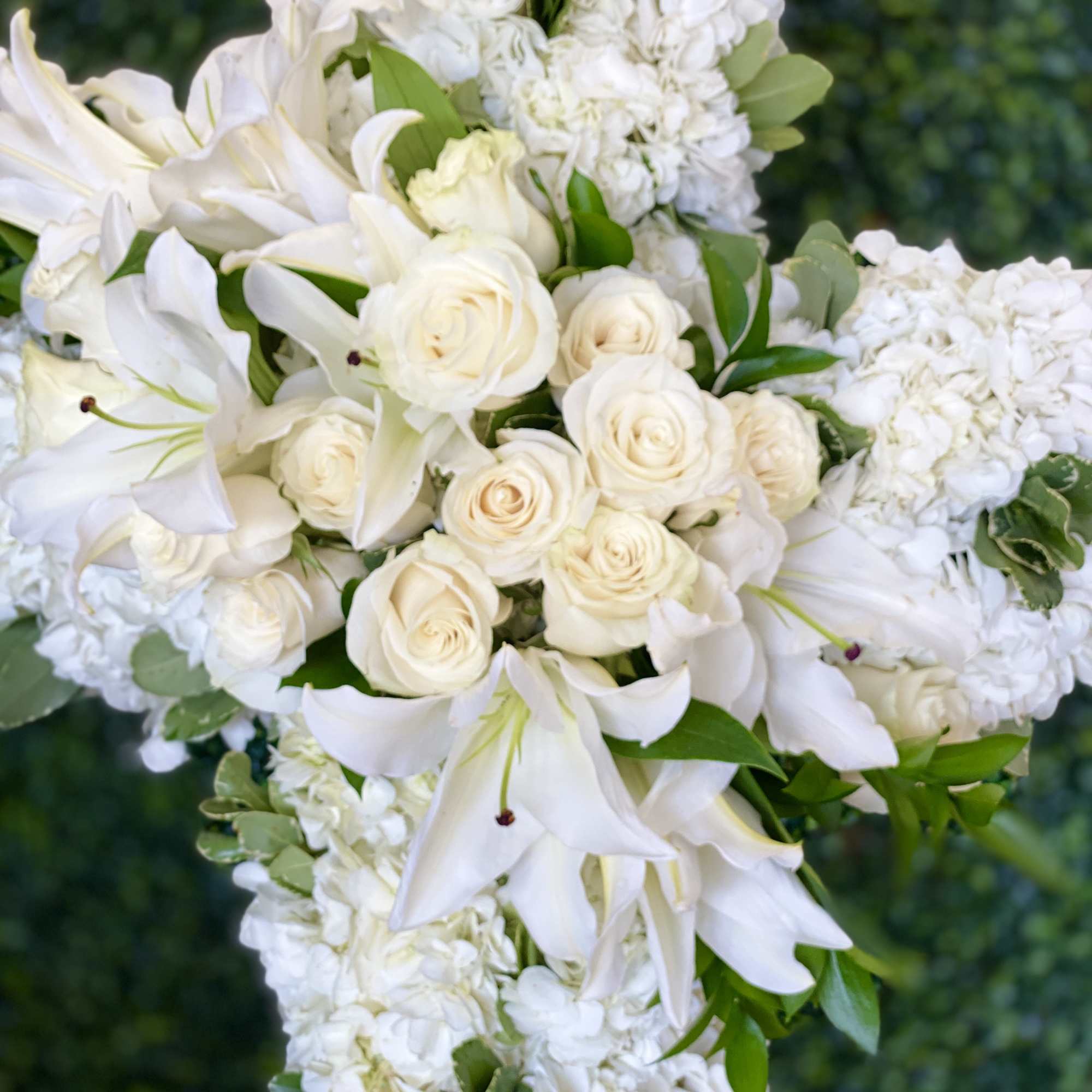 White roses and lilies arranged in a cascading bouquet