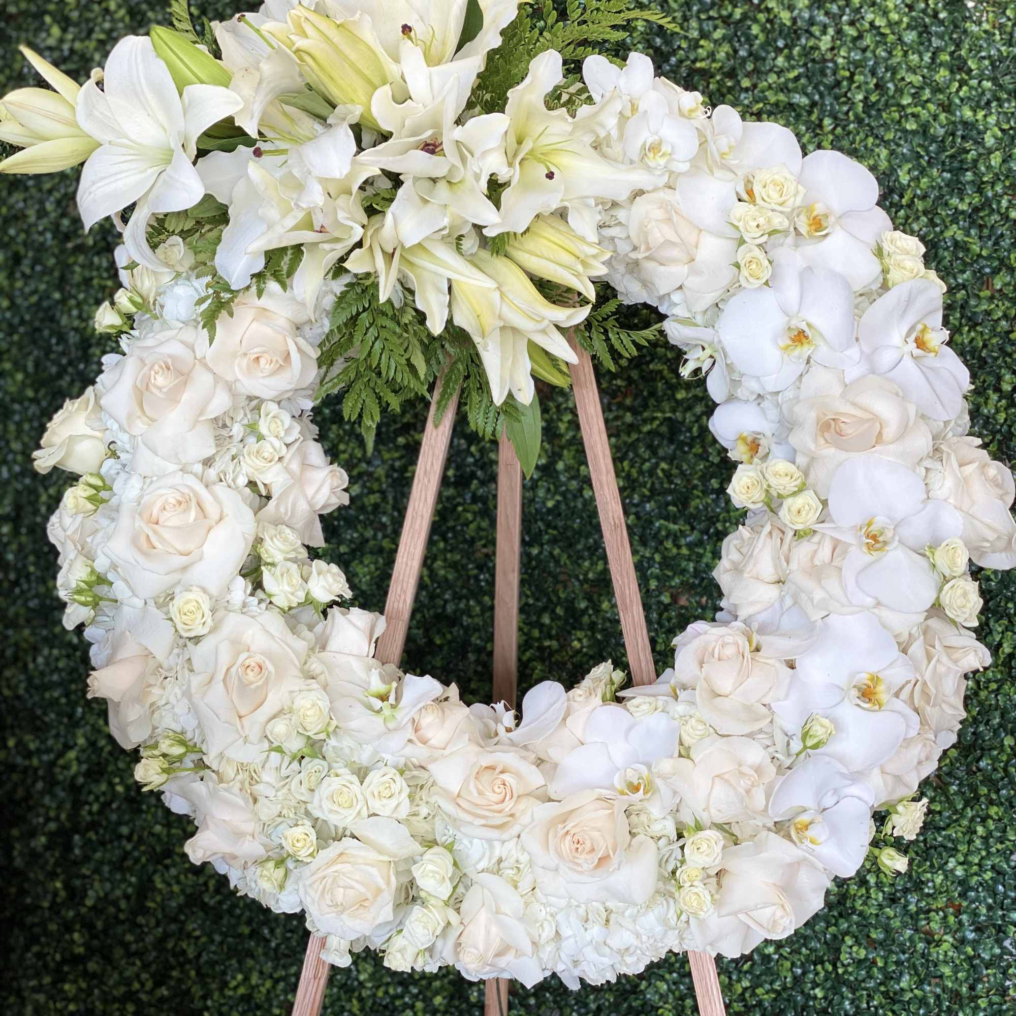 White floral wreath on a wooden easel