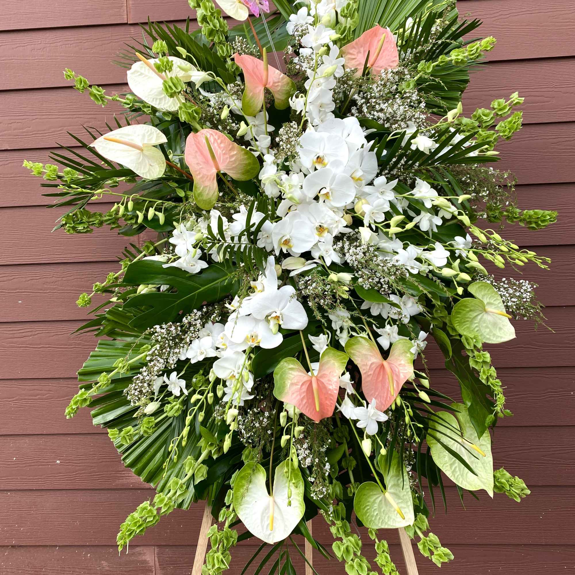 Large standing floral spray with white orchids and pink anthuriums
