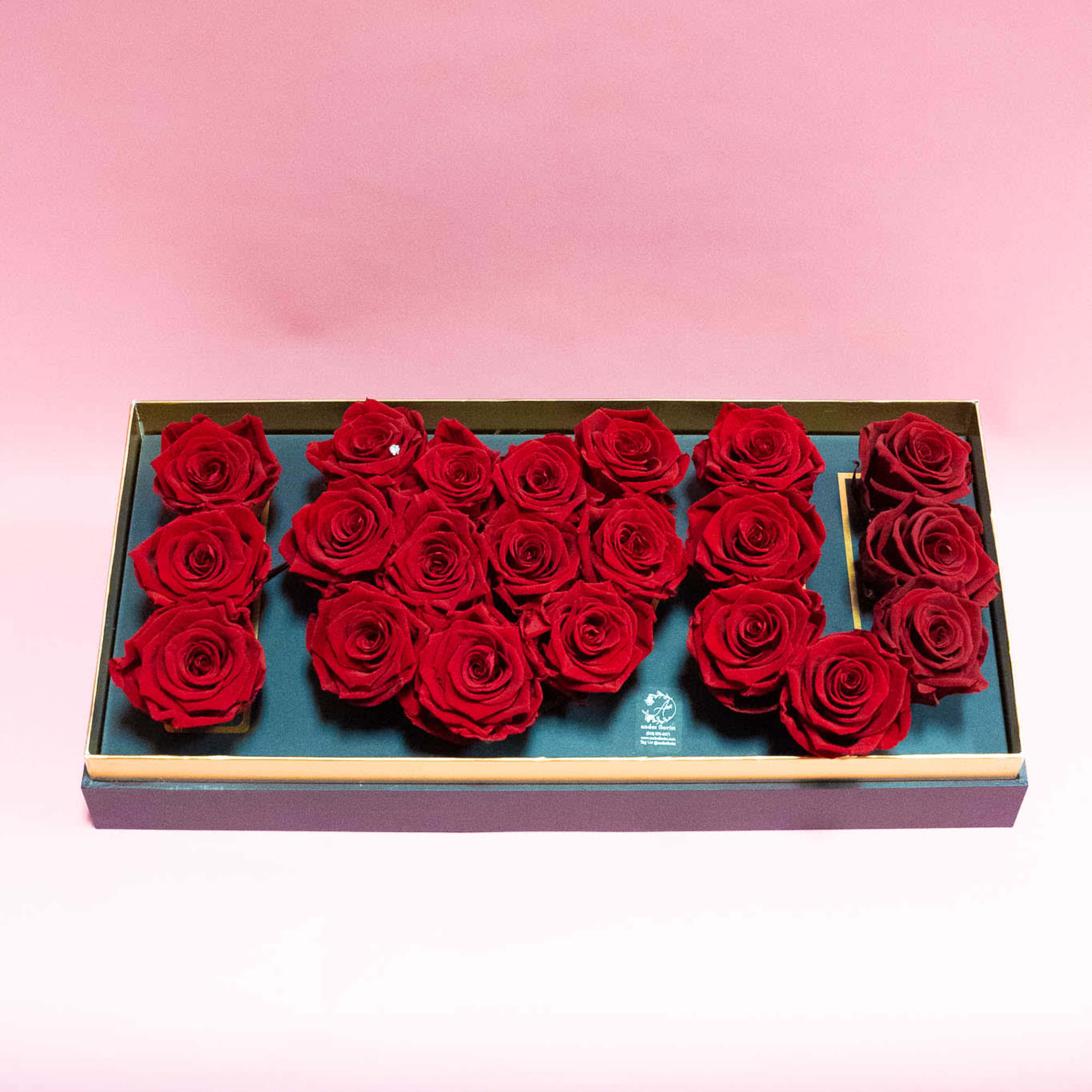 Box of red roses arranged in a rectangular gift box