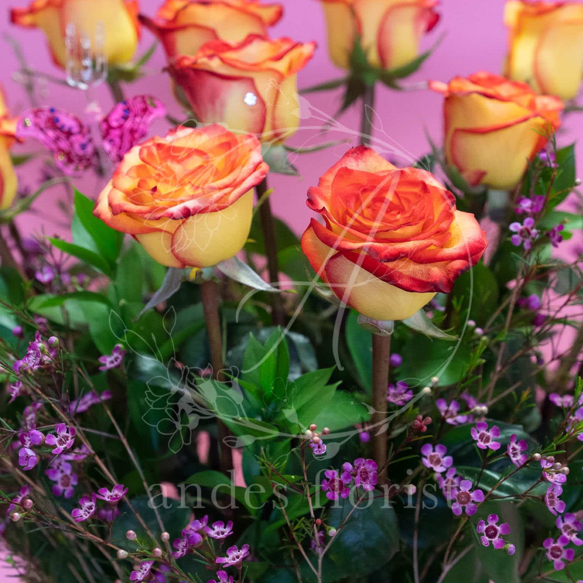 Bouquet of orange-yellow roses with purple filler flowers