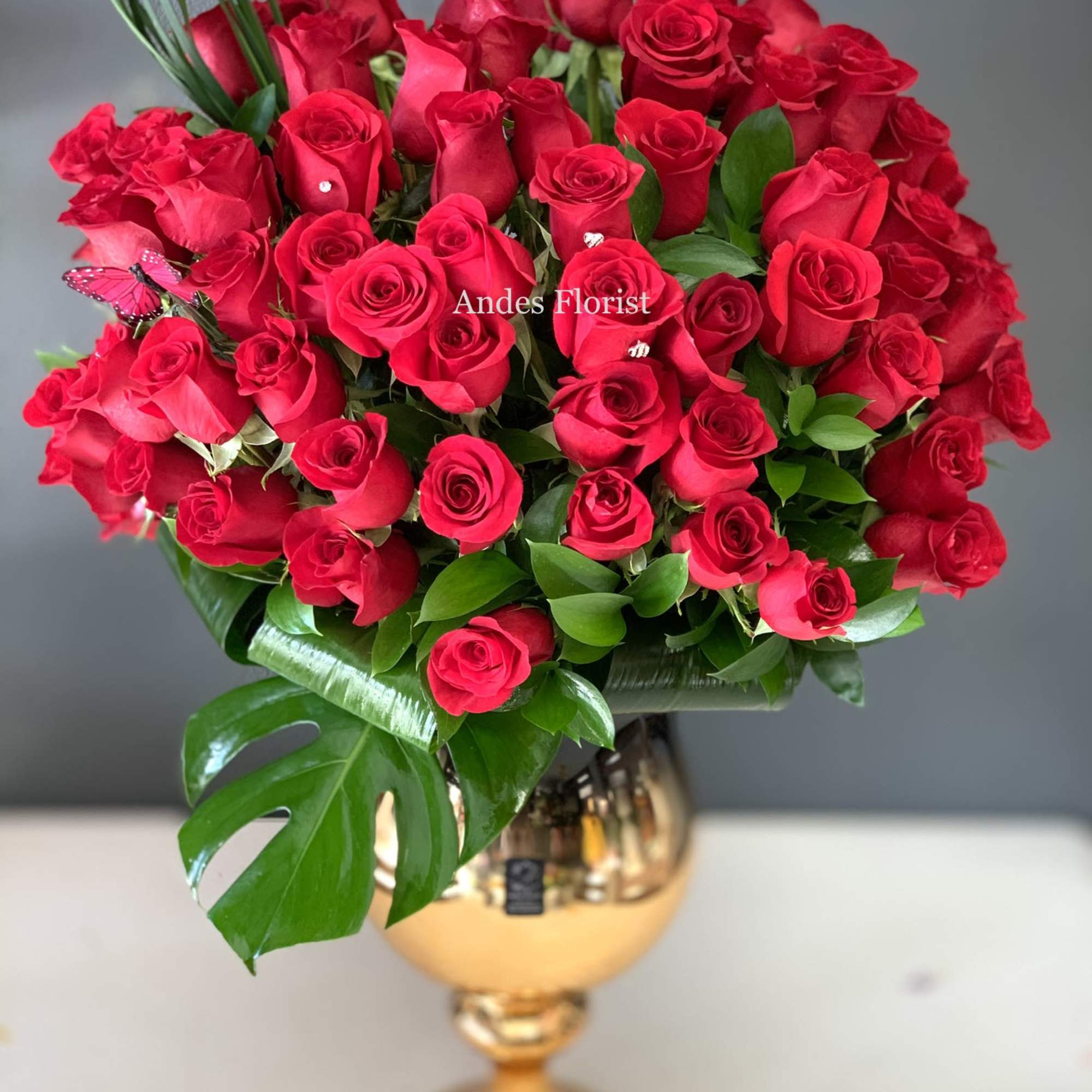 Bouquet of red roses in a gold vase