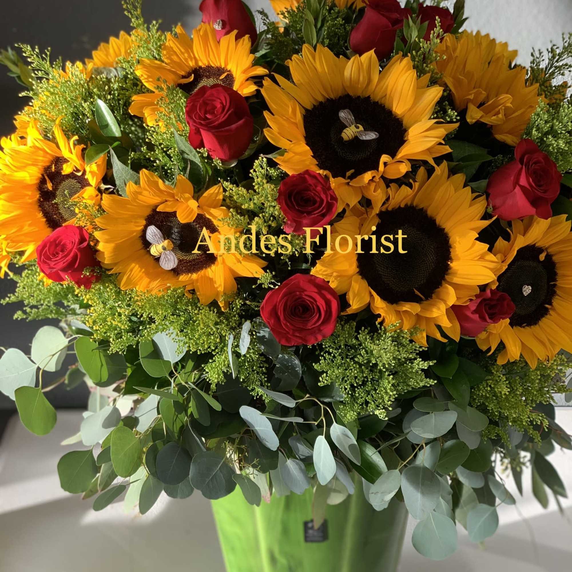 Sunflower and red rose arrangement in a green vase