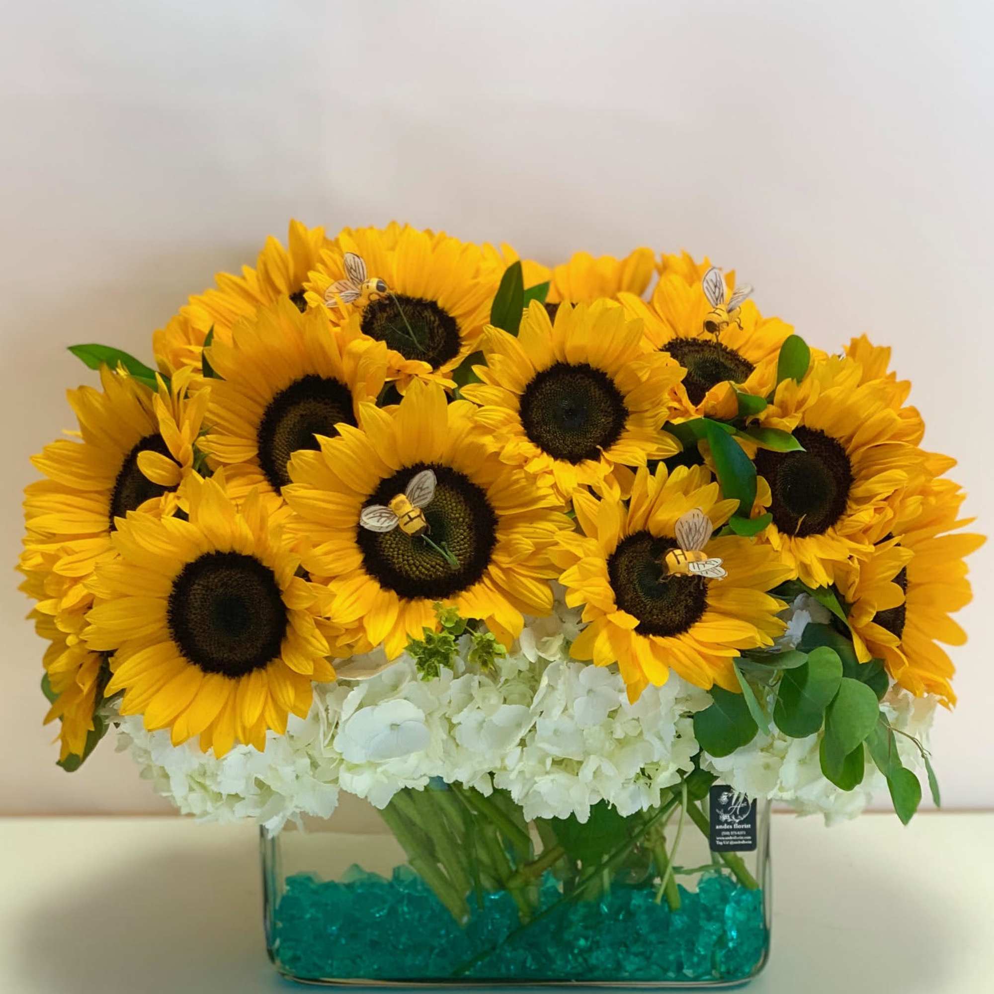 Sunflower arrangement in a clear rectangular vase with white hydrangeas, photo 4 of 4