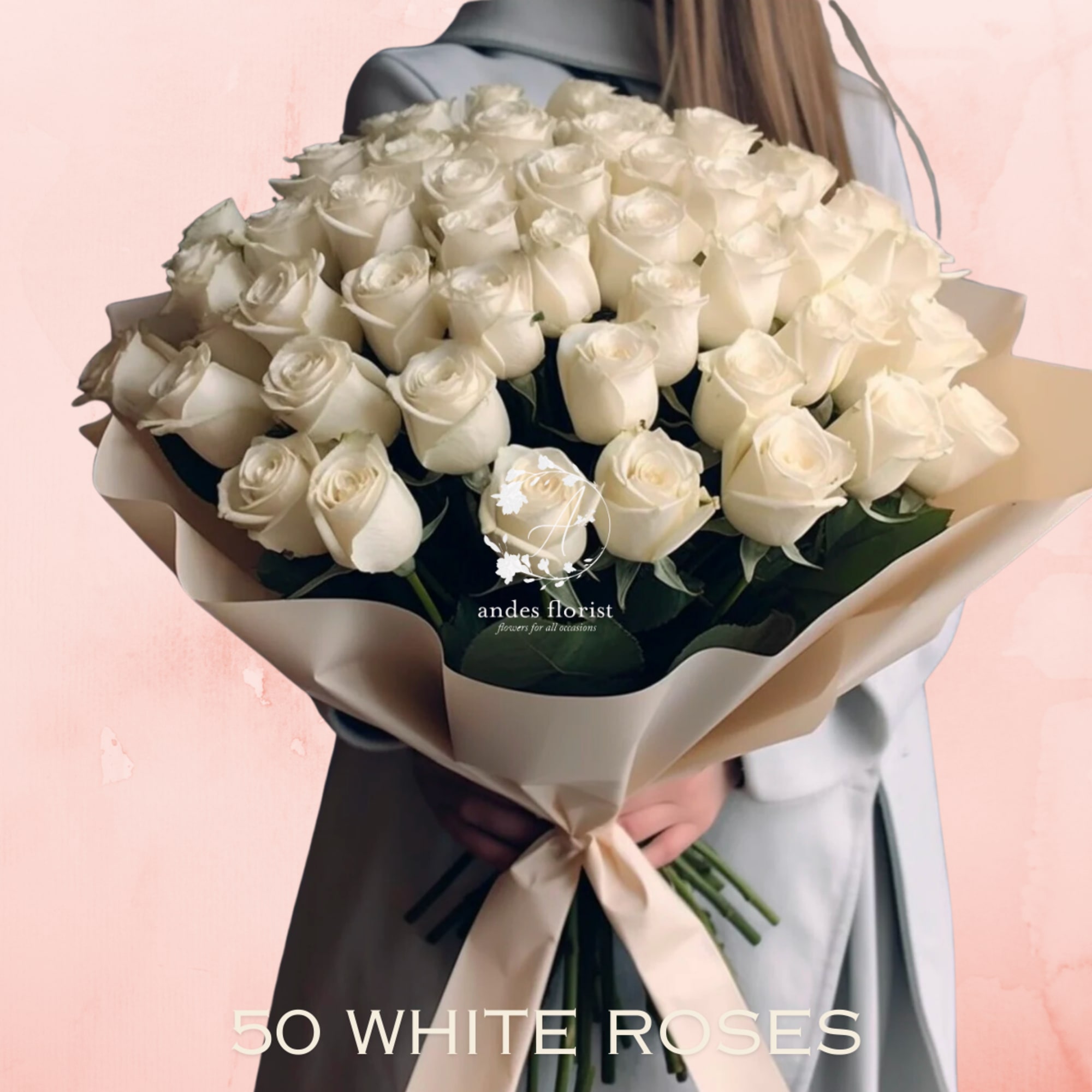 Bouquet of white roses wrapped in beige paper with a ribbon