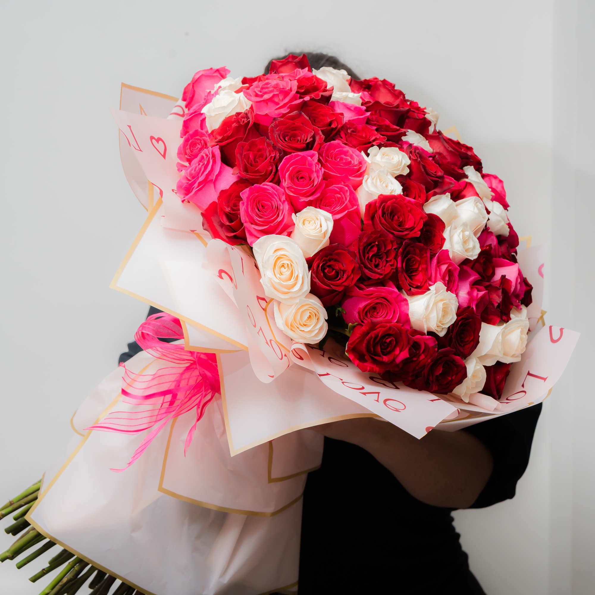 Large bouquet of red, pink, and white roses wrapped in pink paper, photo 2 of 10