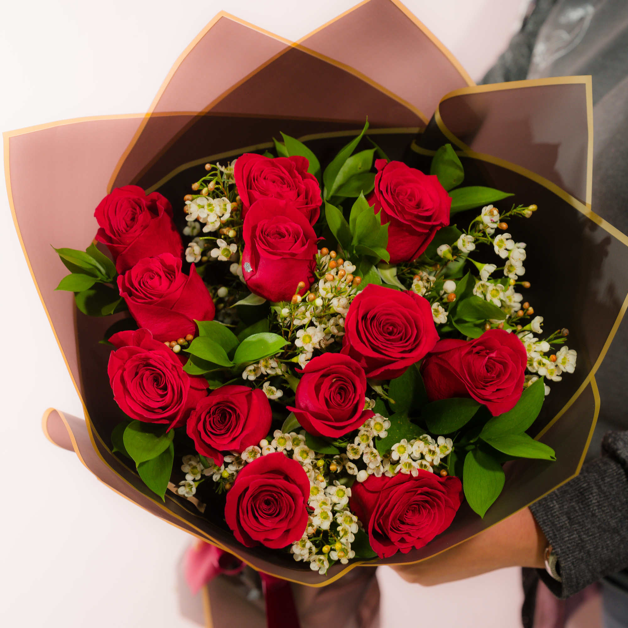 Bouquet of red roses with small white filler flowers
