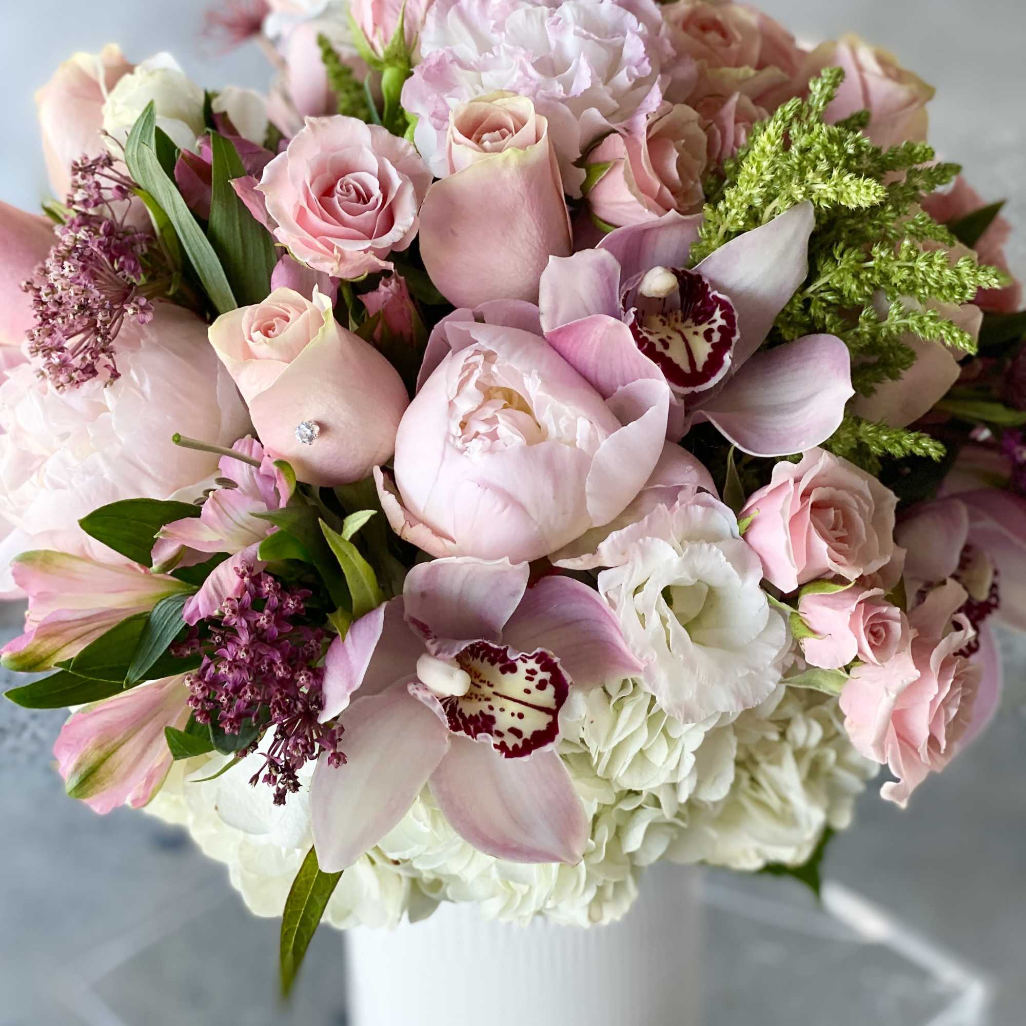 Pink and white bouquet in a white vase