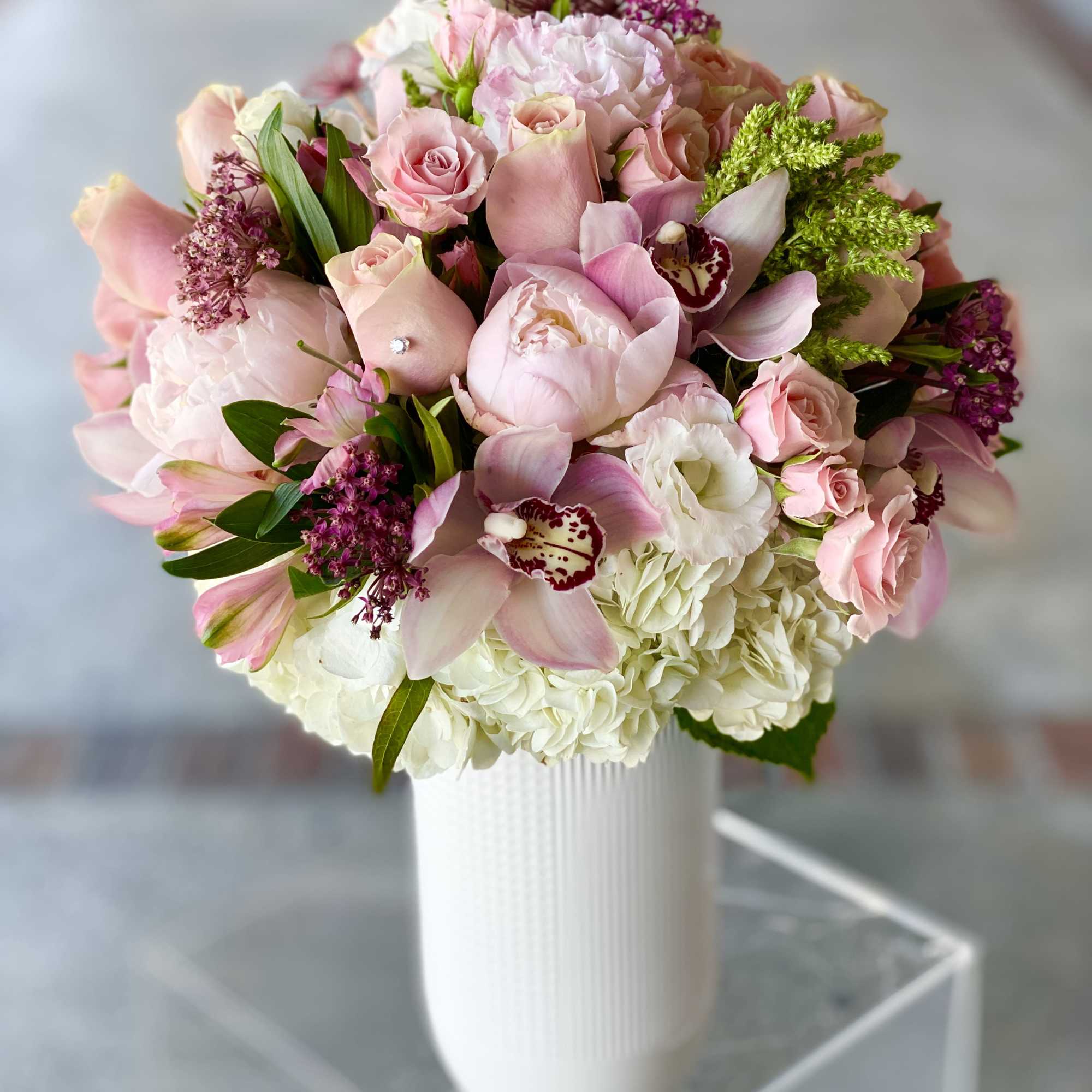 Pink and white bouquet in a white vase