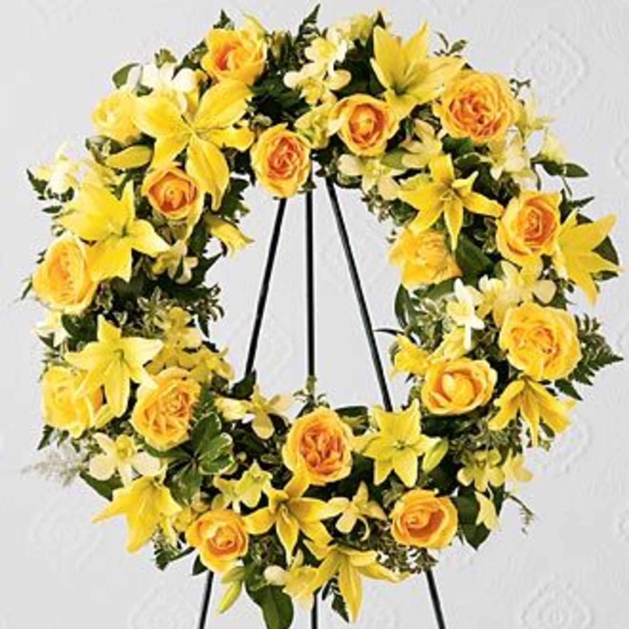 Yellow floral wreath on a black easel stand
