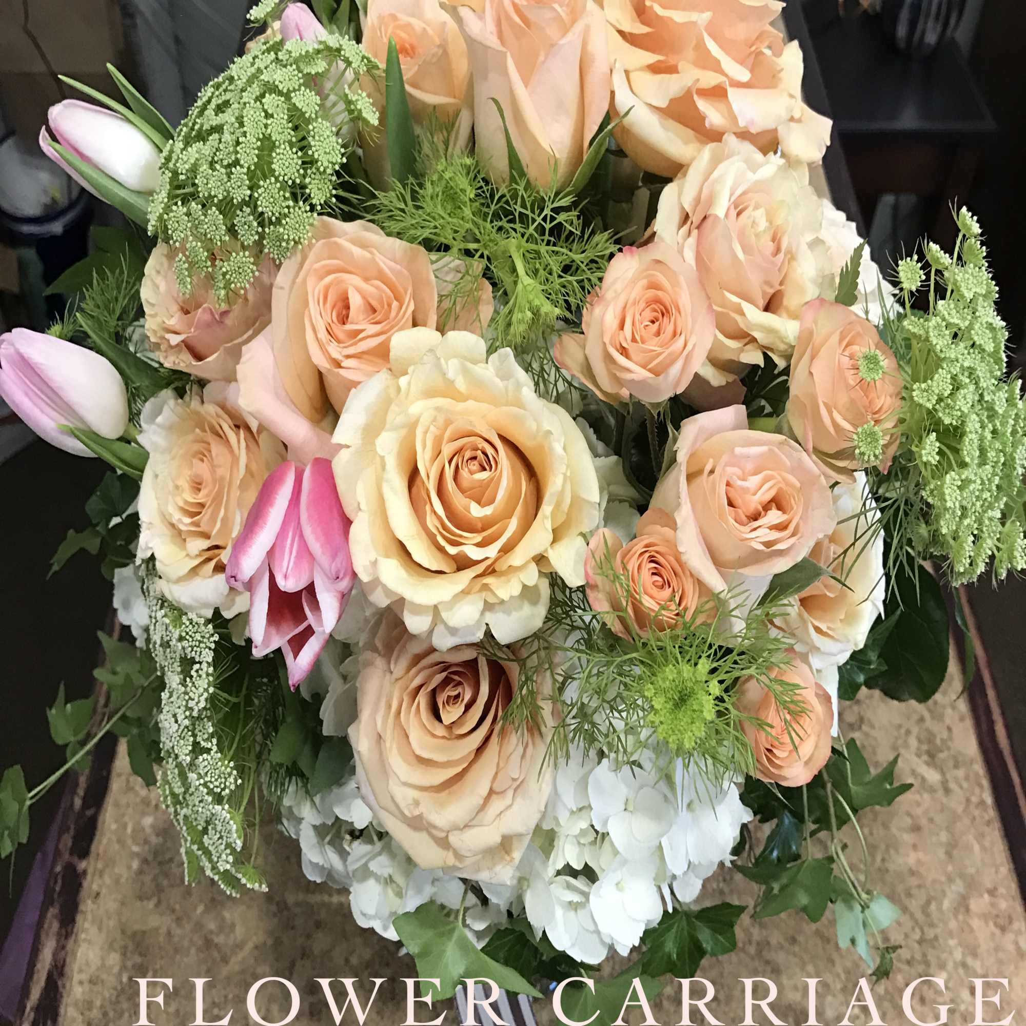 Peach roses and pink tulips in a hand-tied bouquet