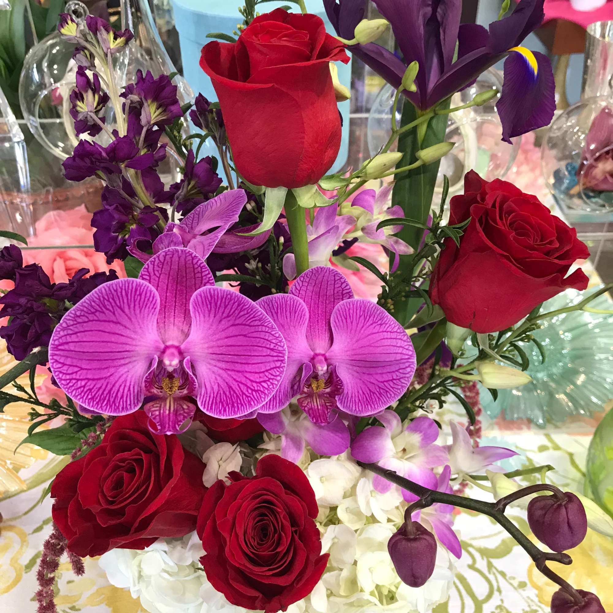 Red roses and purple orchids in a mixed bouquet