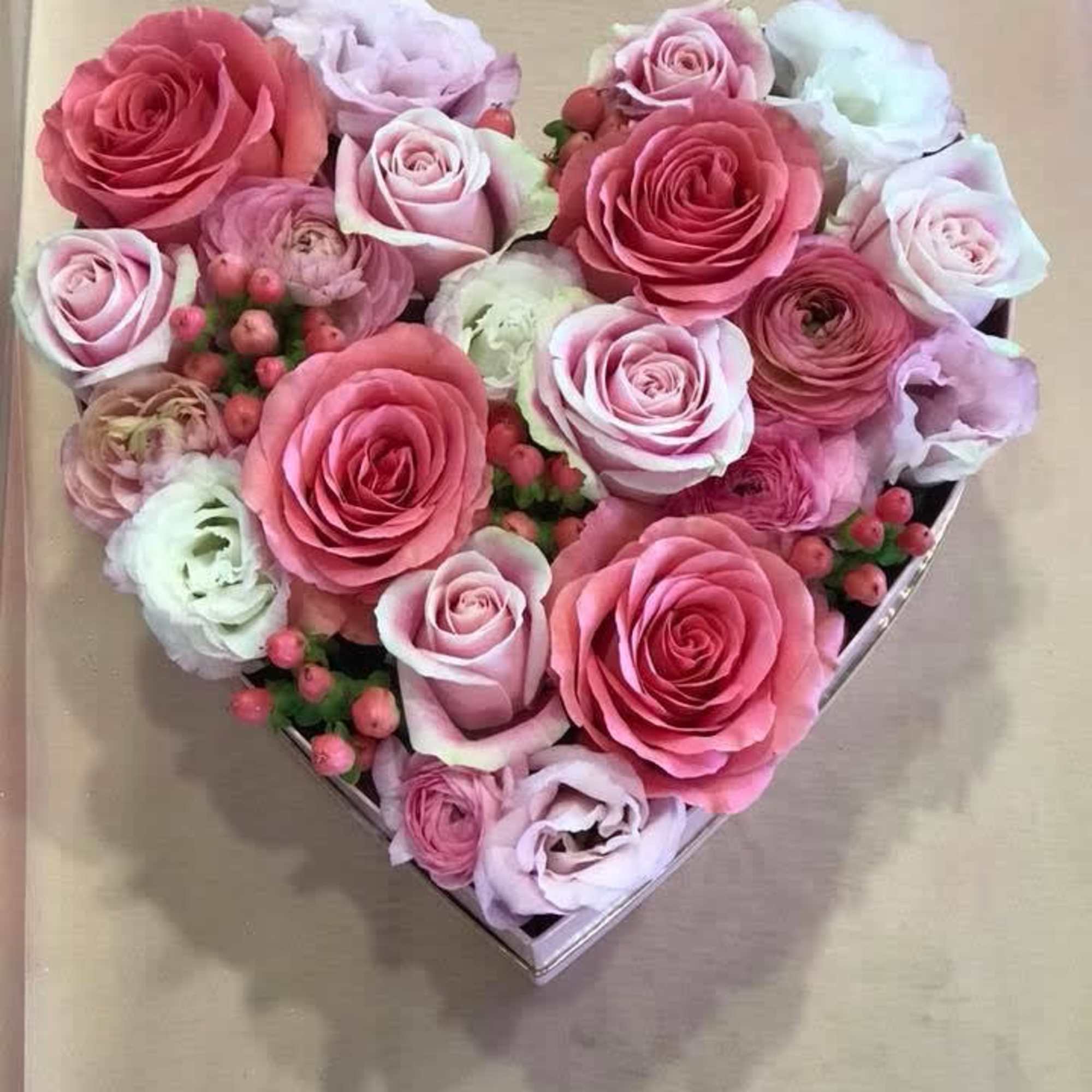 Heart-shaped box filled with pink and white roses