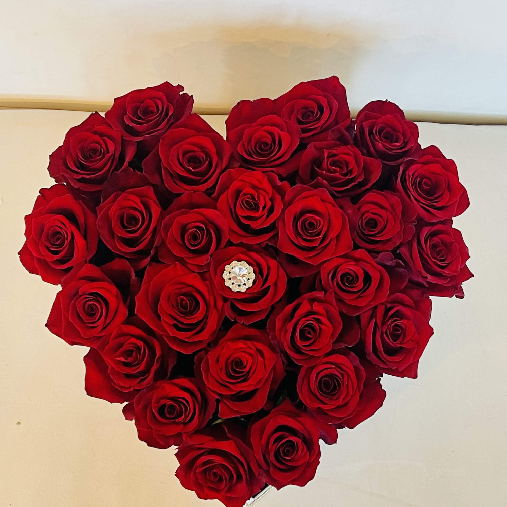 A sculpted heart of velvety red roses makes an unforgettable centerpiece for, photo 2 of 3