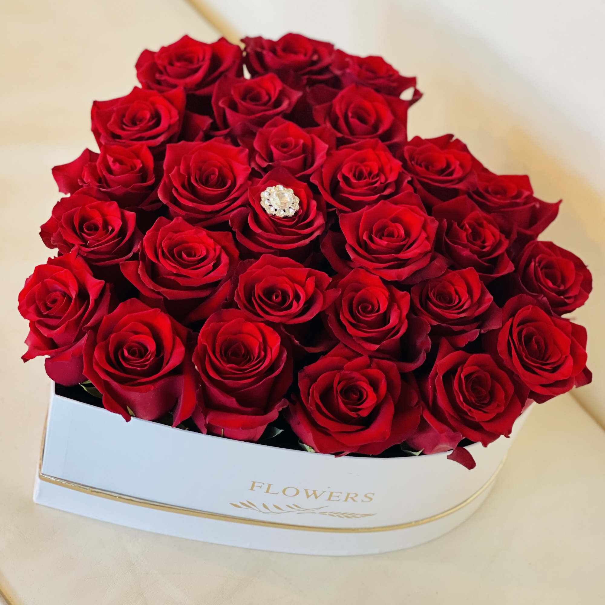 A sculpted heart of velvety red roses makes an unforgettable centerpiece for