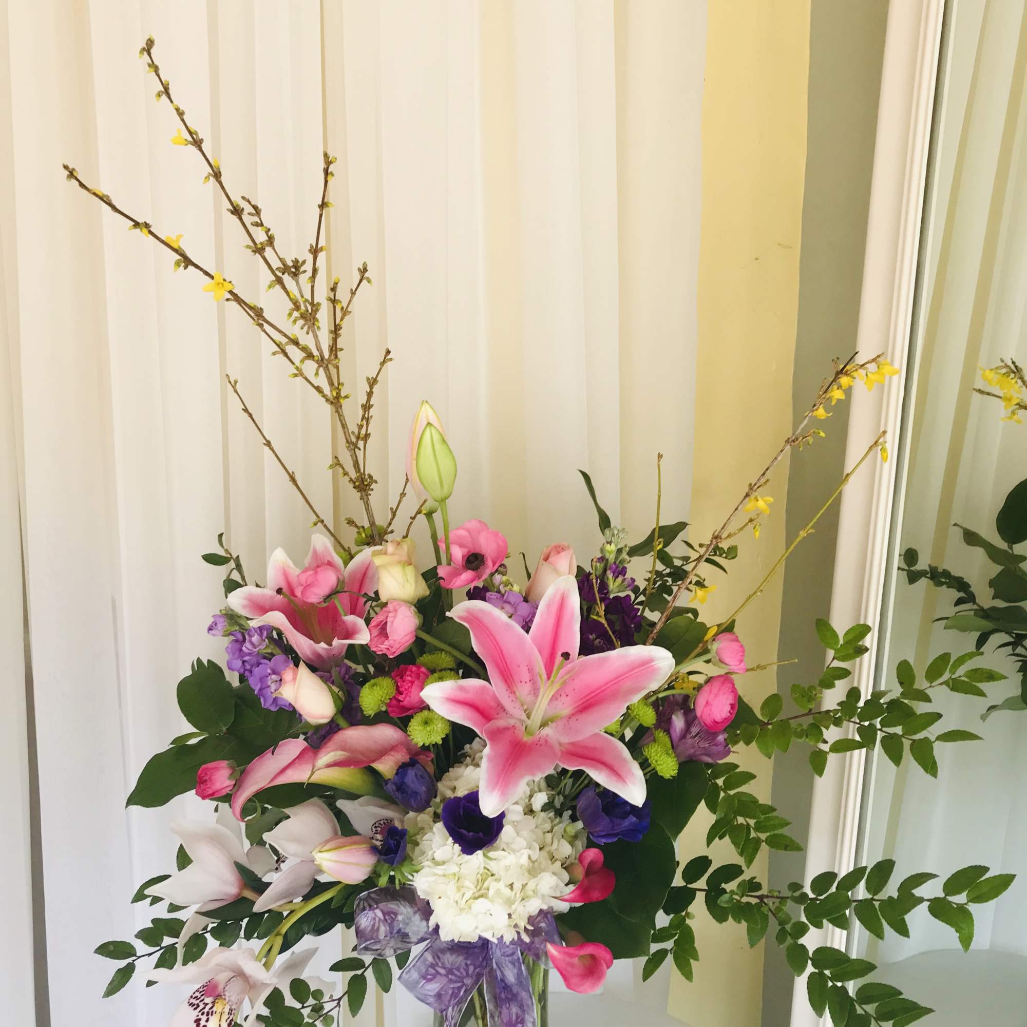 Pink lilies and mixed flowers in a glass vase with a purple ribbon, photo 2 of 2