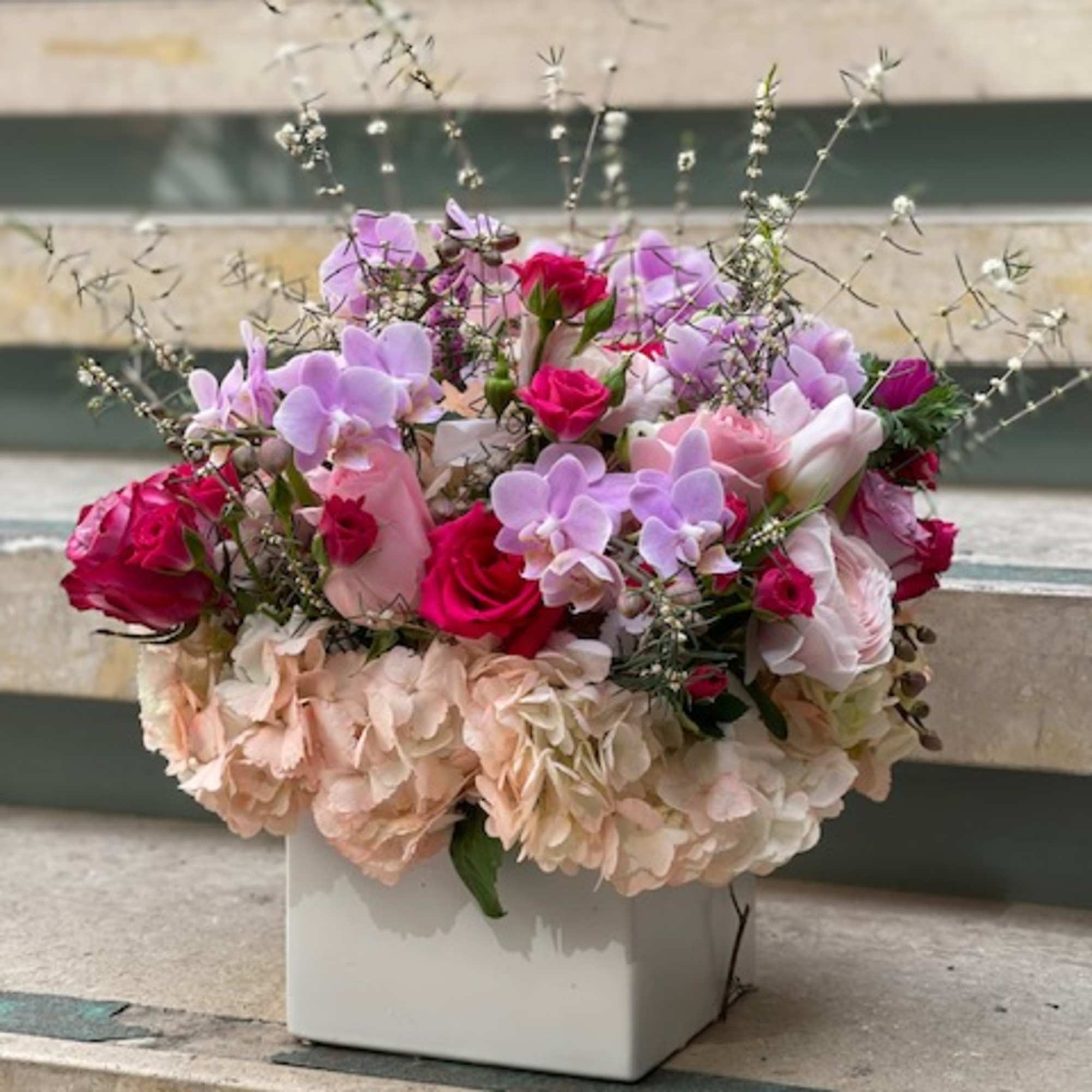 Pink and lavender floral arrangement in a white square vase, photo 13 of 14