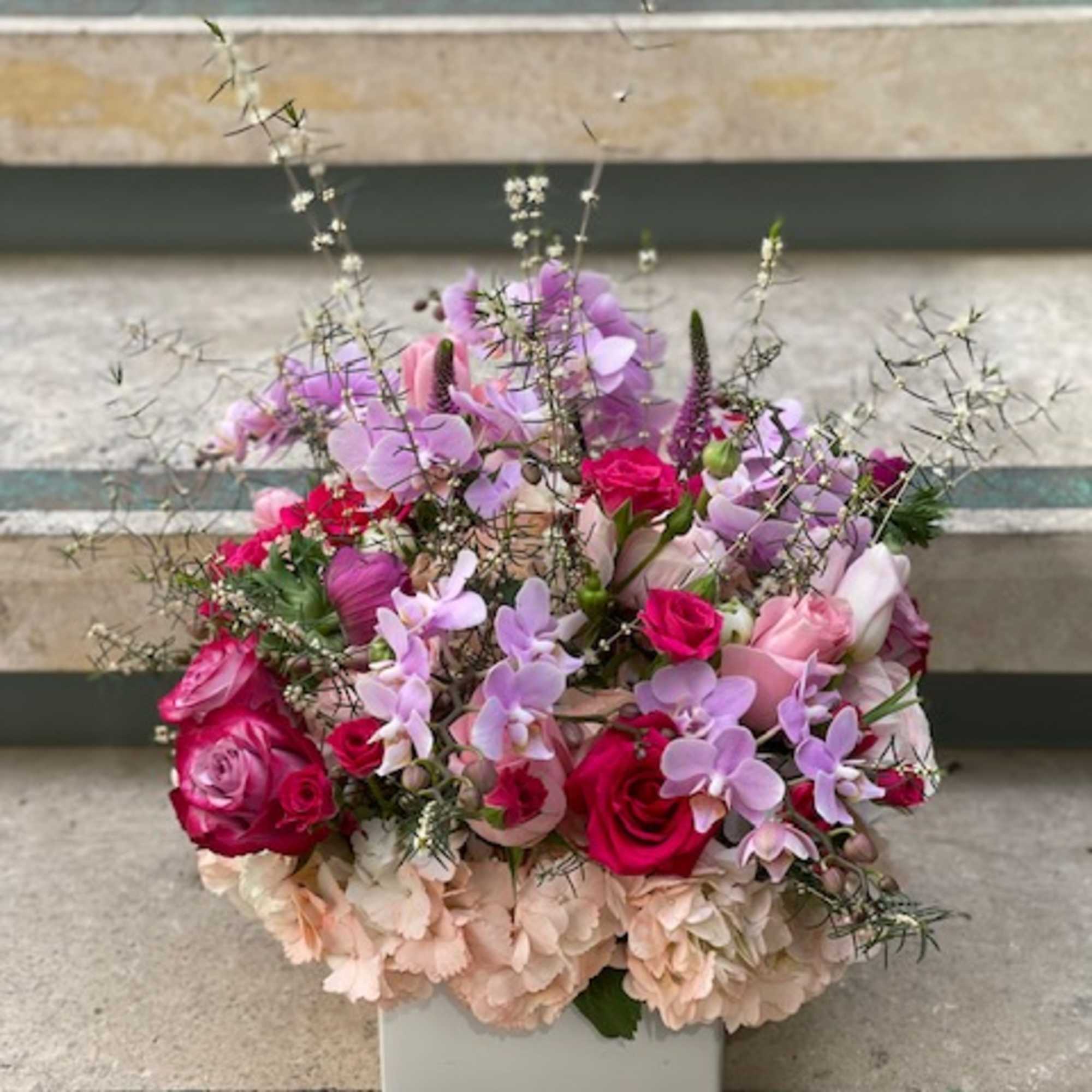 Pink and lavender floral arrangement in a white square vase, photo 11 of 14