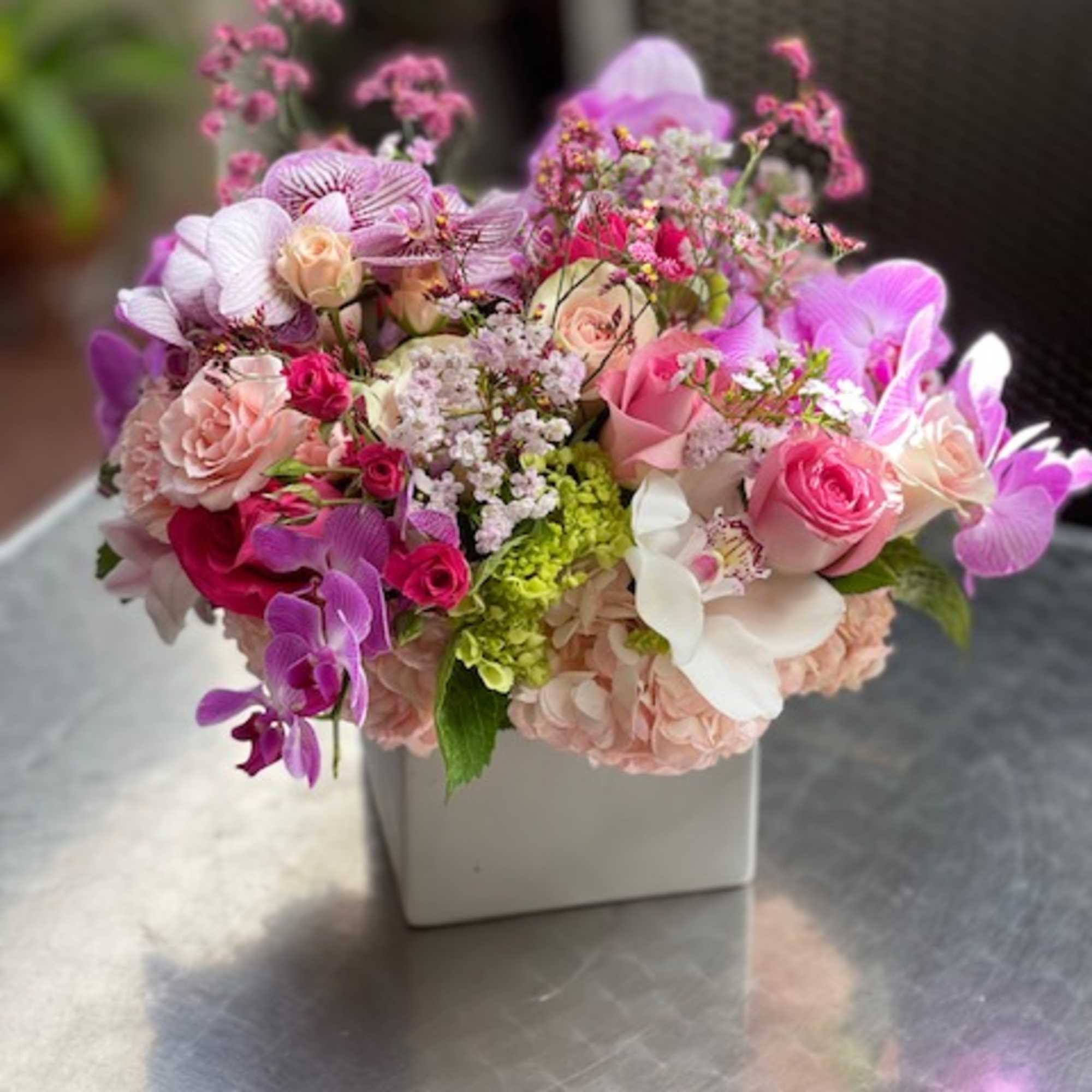 Pink and purple mixed flower arrangement in a white square vase, photo 4 of 14