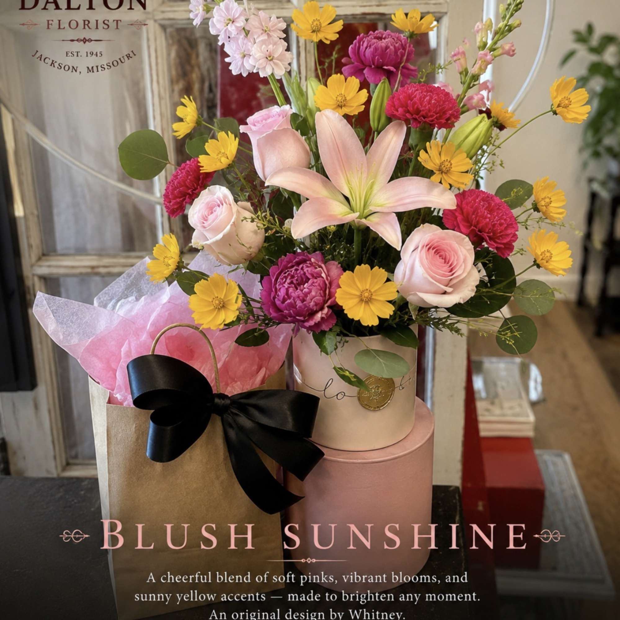 Mixed bouquet with pink roses, lilies, and yellow daisies in a gift box