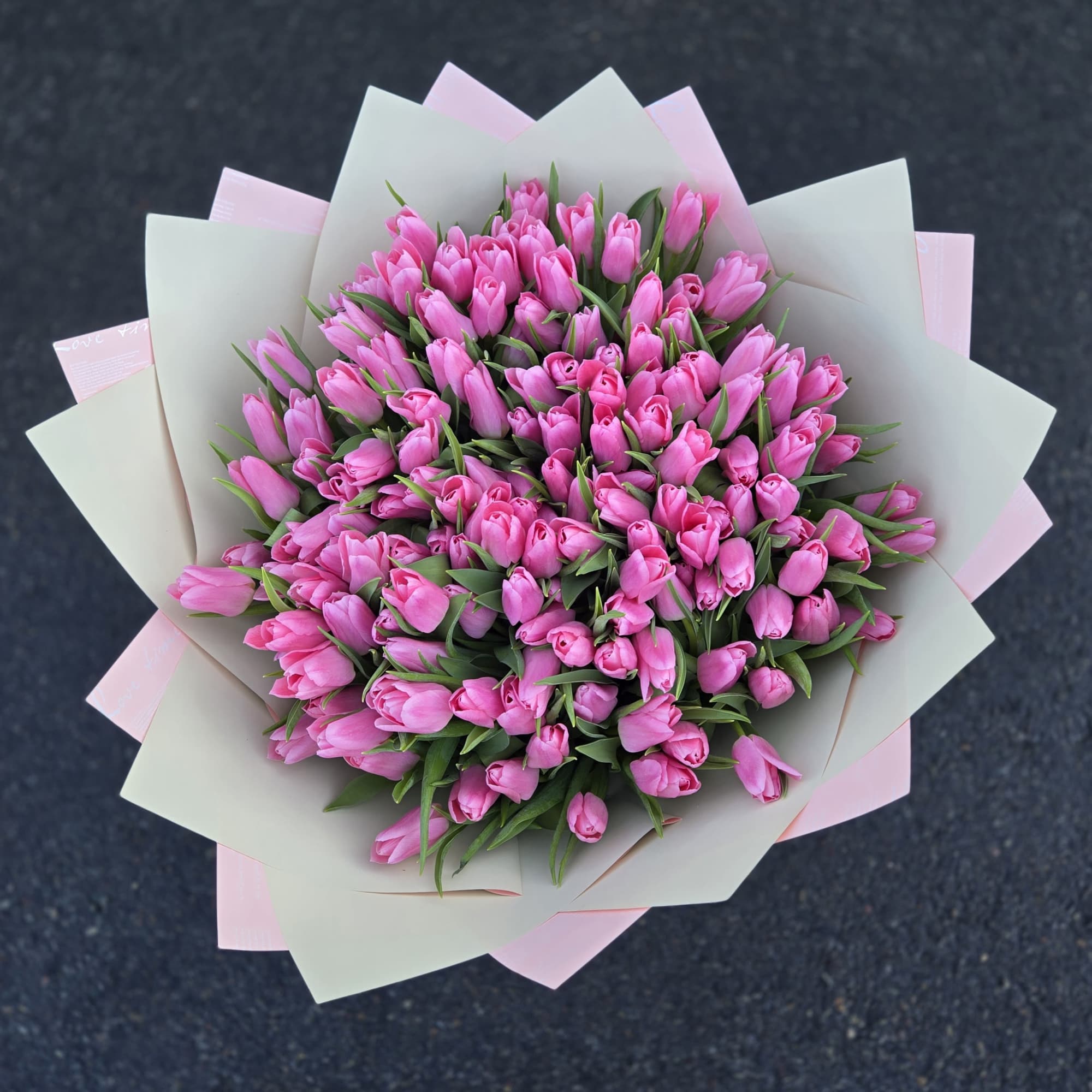 Bouquet of pink tulips wrapped in pale paper, photo 2 of 3