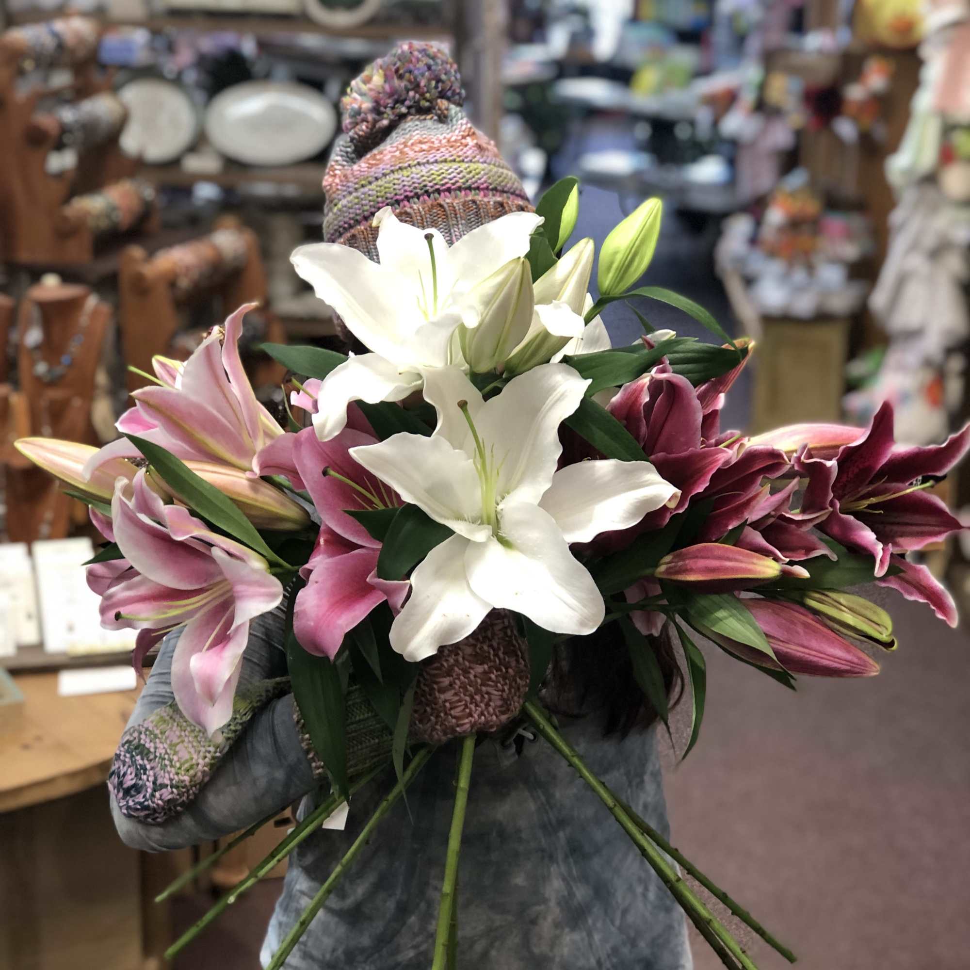 Handheld bouquet of pink and white lilies