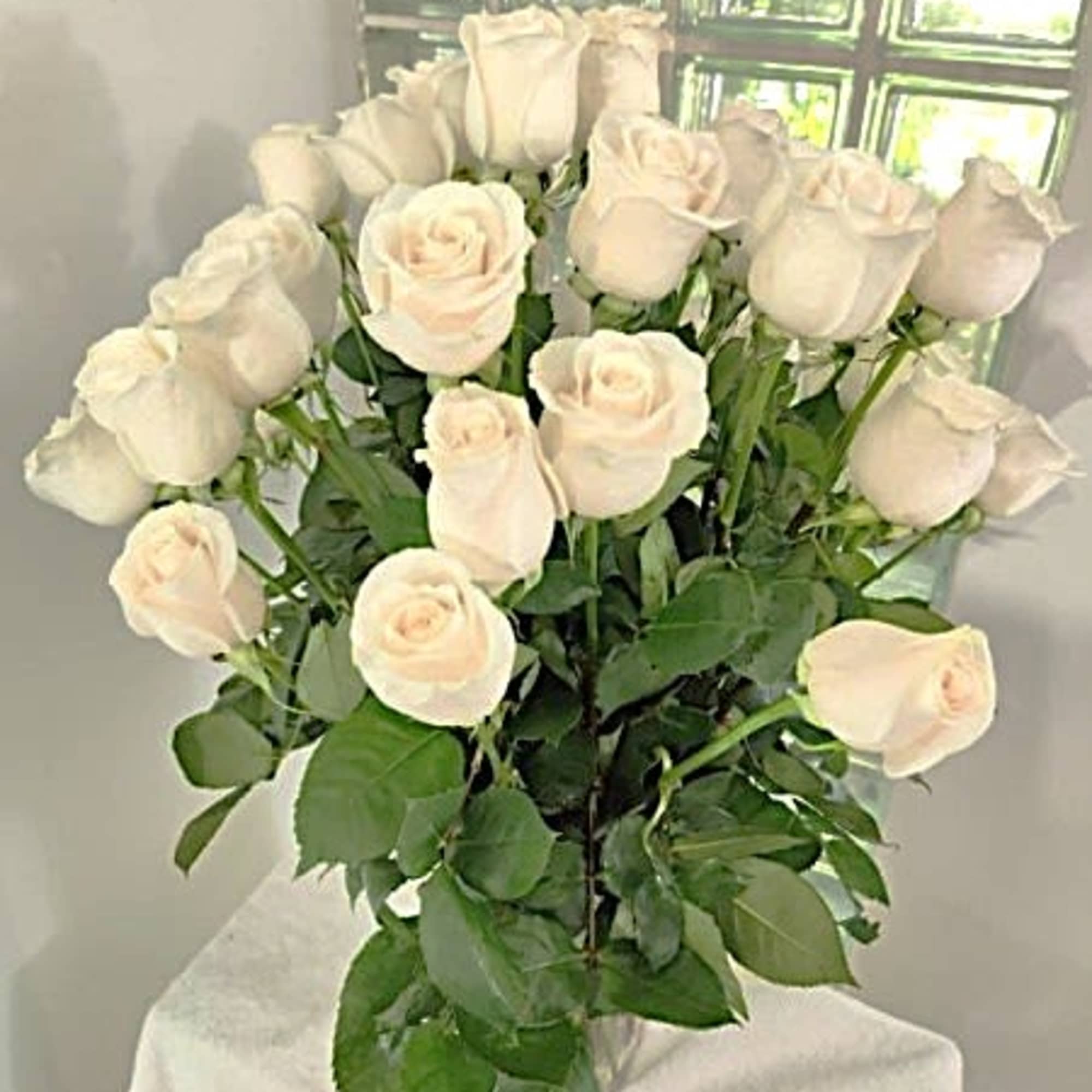 Bouquet of white roses with greenery