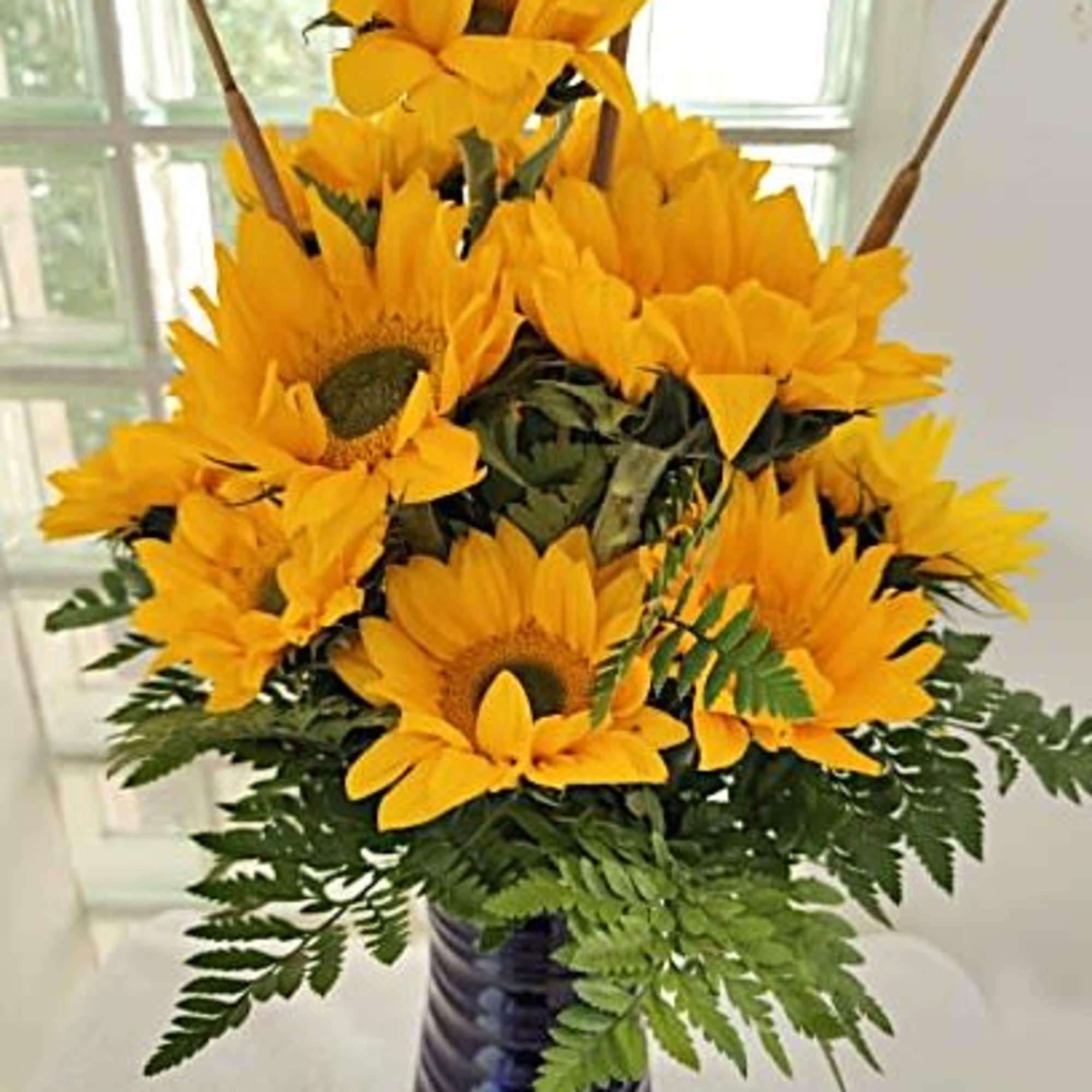 We've mixed bright and cheery sunflowers into a cobalt blue vase for