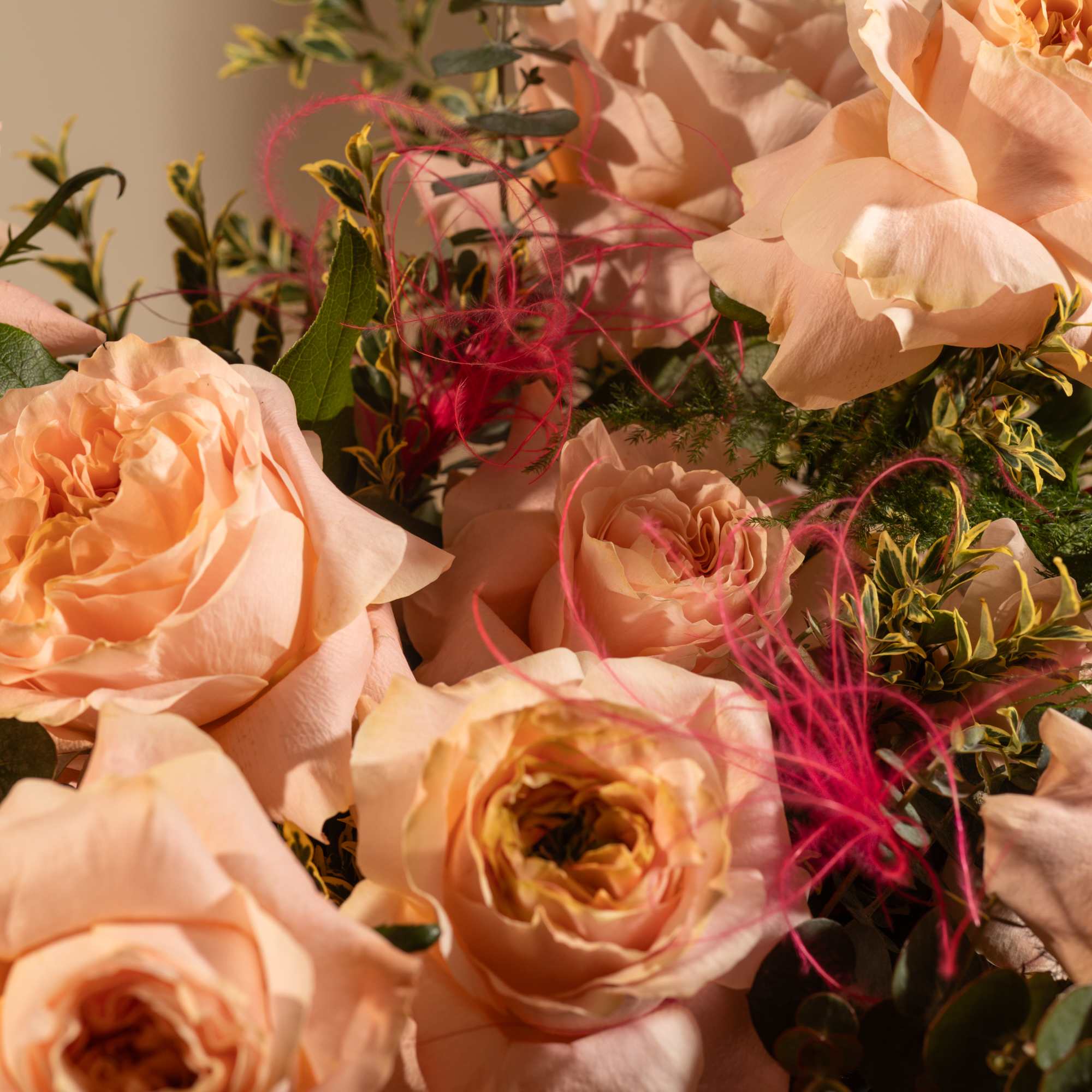 Peach roses with pink accents and greenery