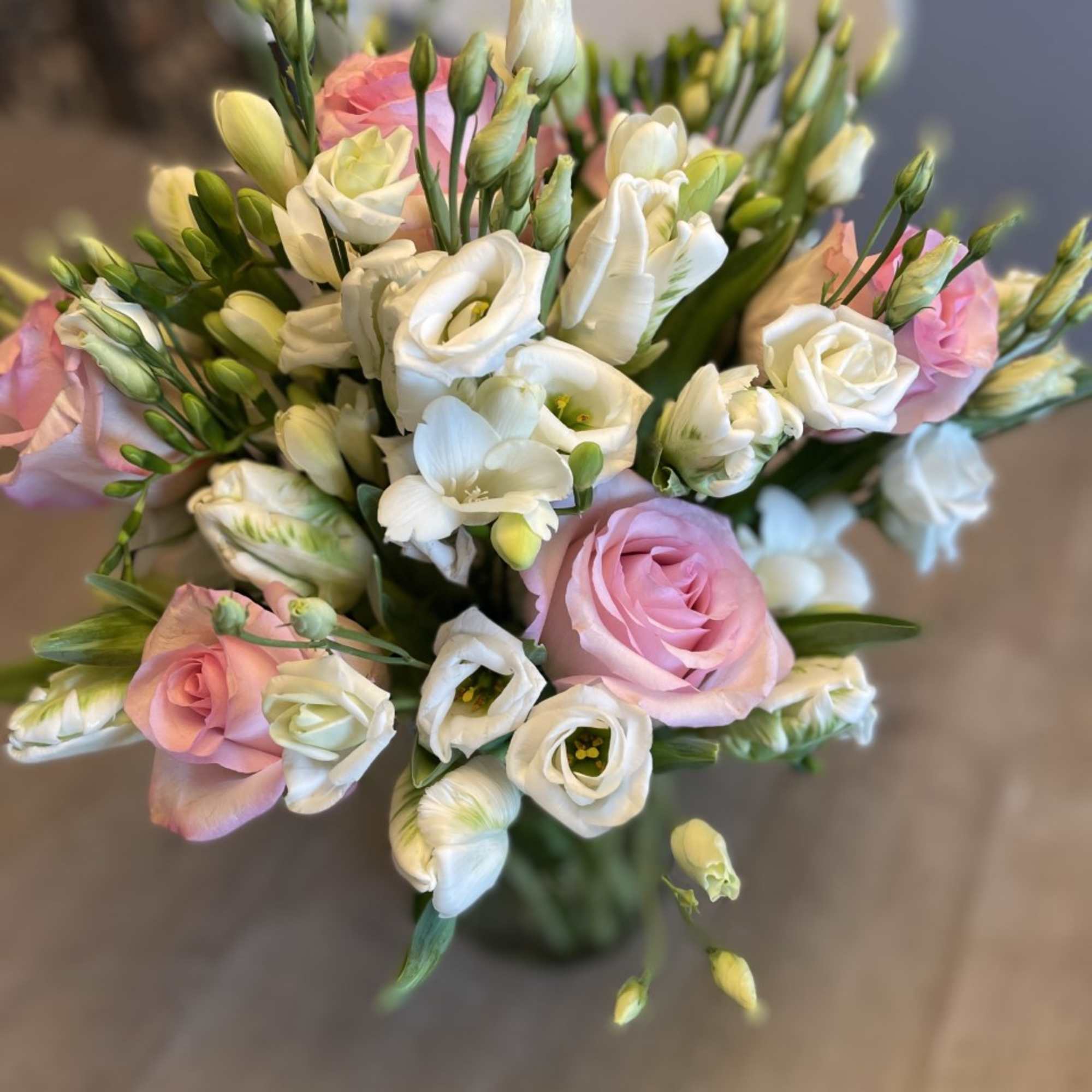 Bouquet of pink and white flowers with long green buds