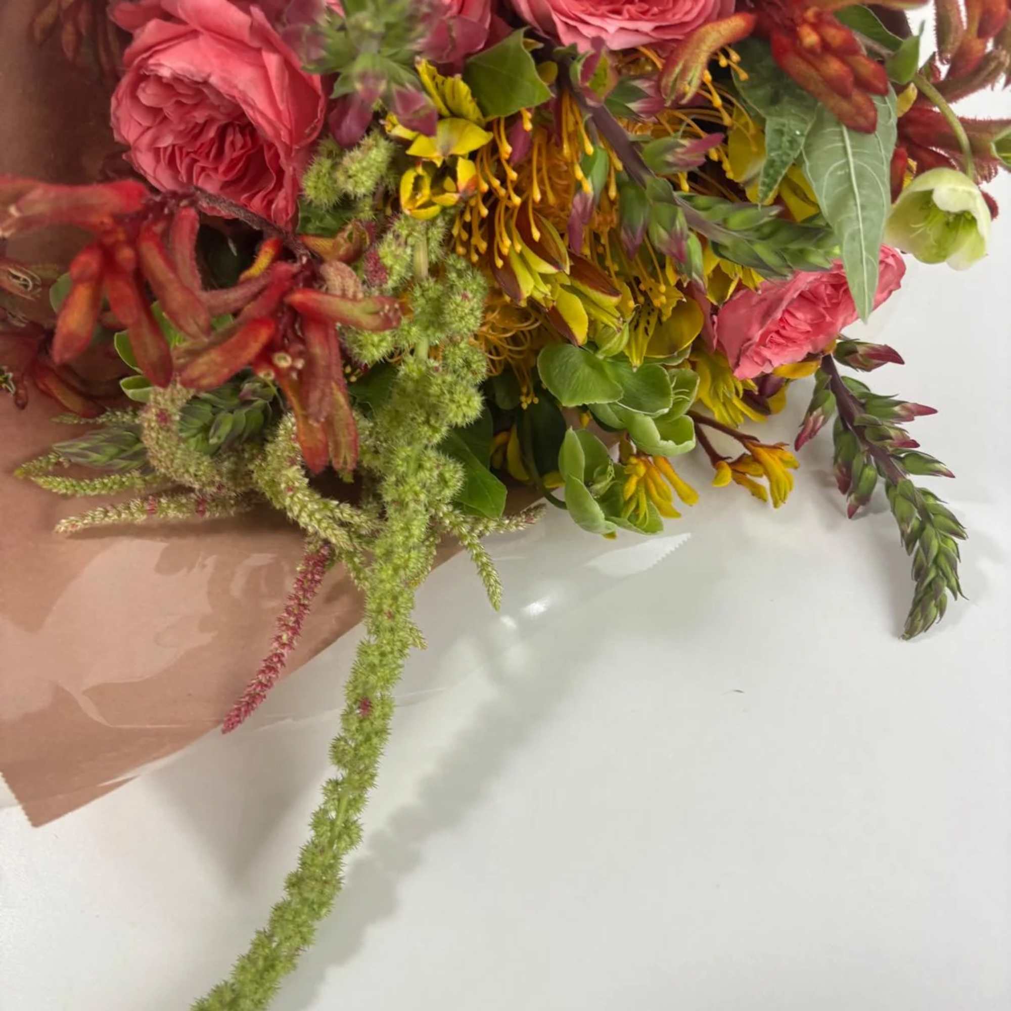 Bouquet of pink roses with yellow and green mixed flowers