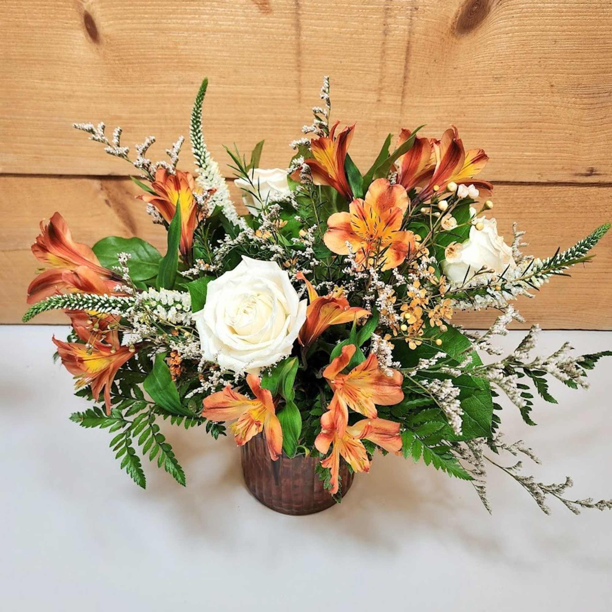 Warm and elegant, the Falling For You bouquet blends rich seasonal hues