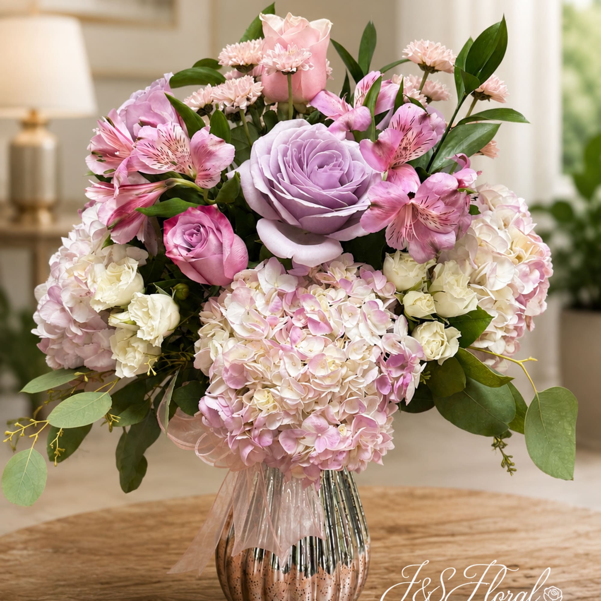 Pink and lavender bouquet with roses, hydrangeas, and alstroemeria in a metallic vase