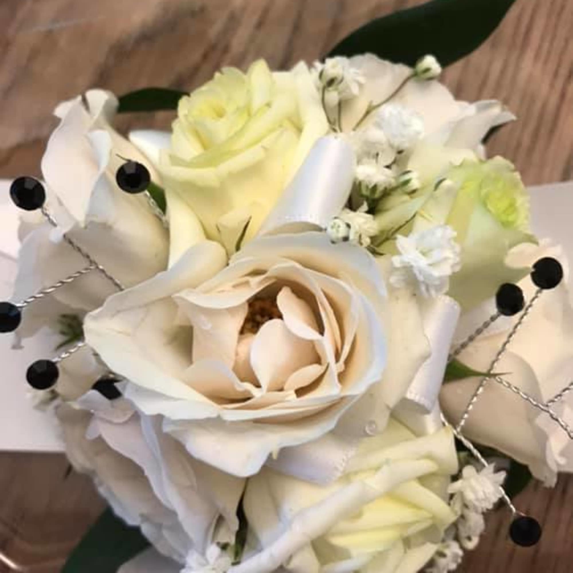Cream and white rose bouquet with small white filler flowers