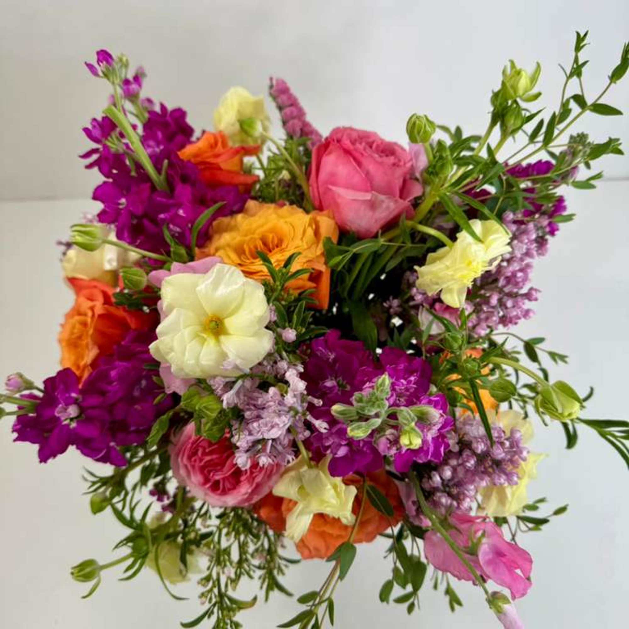 Colorful mixed bouquet with pink, orange, yellow, and purple flowers