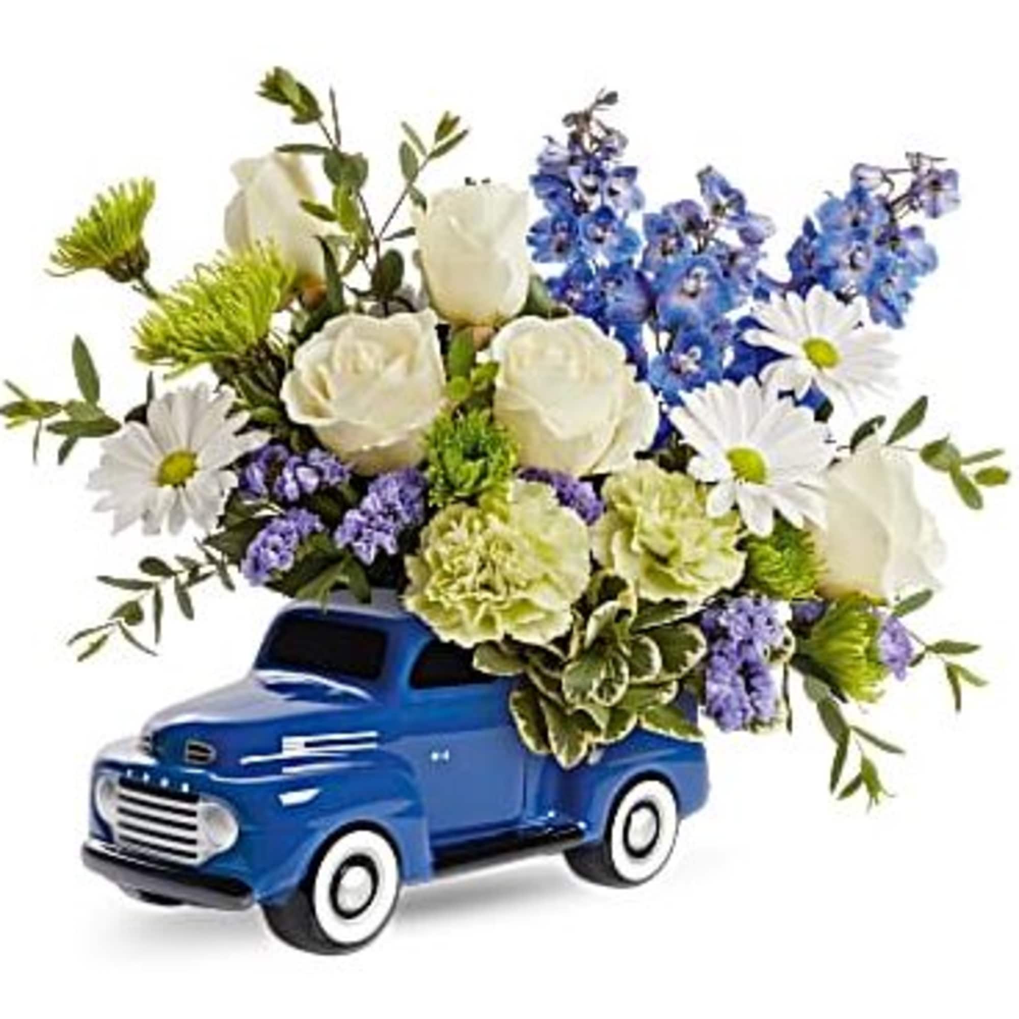 Bursting with a whimsical blue, white and green bouquet, this fun-filled ceramic