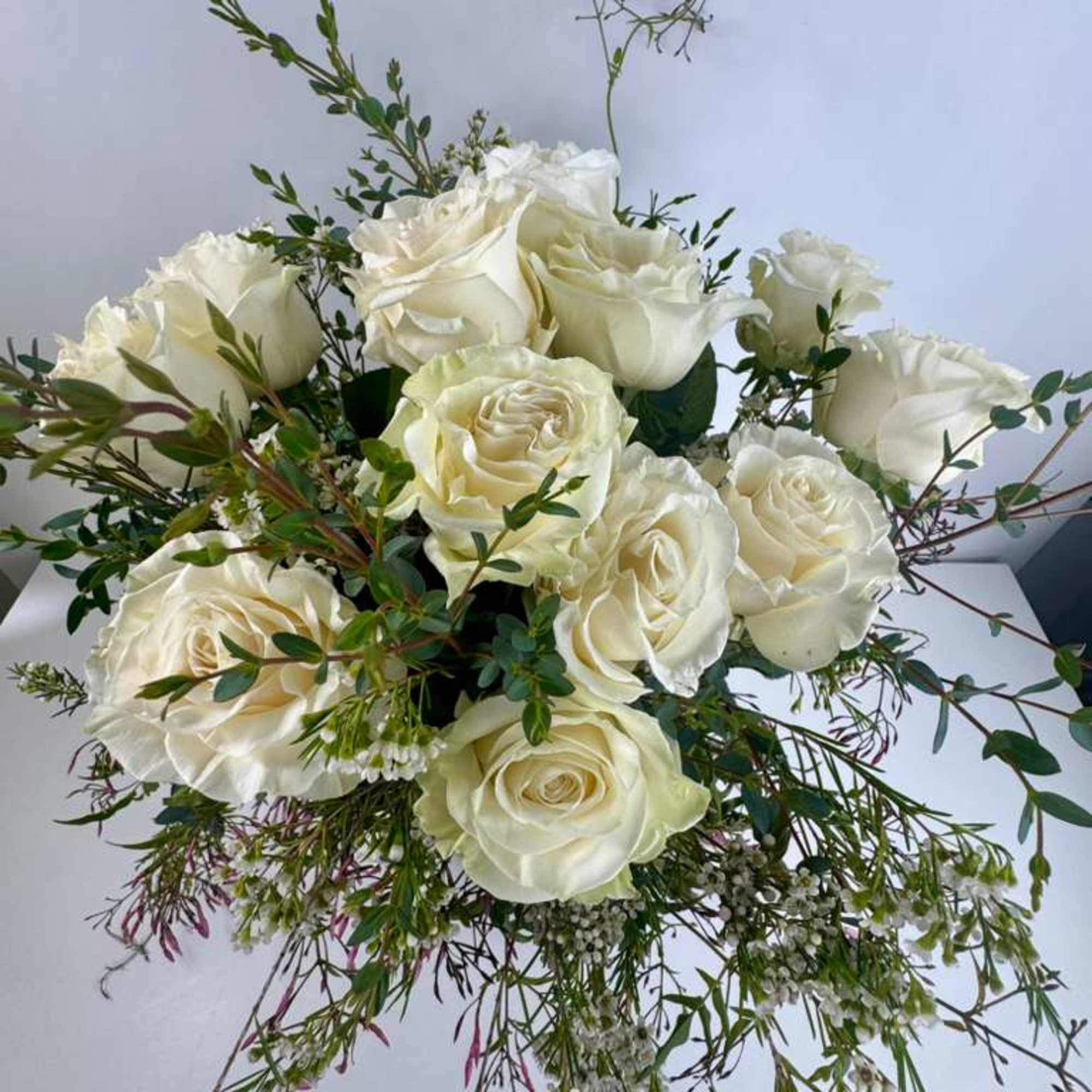 Bouquet of white roses with airy greenery