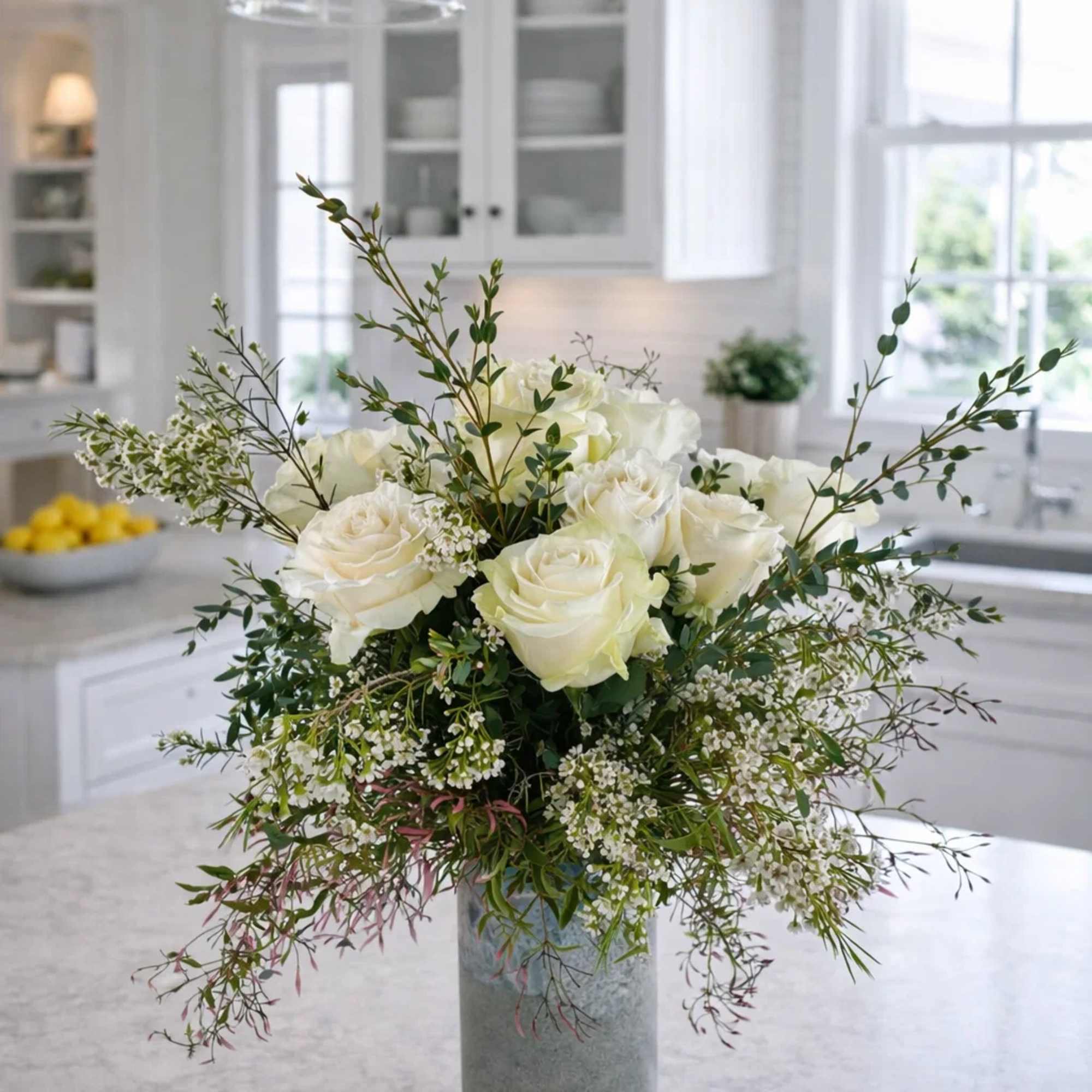 White rose arrangement in a tall gray vase