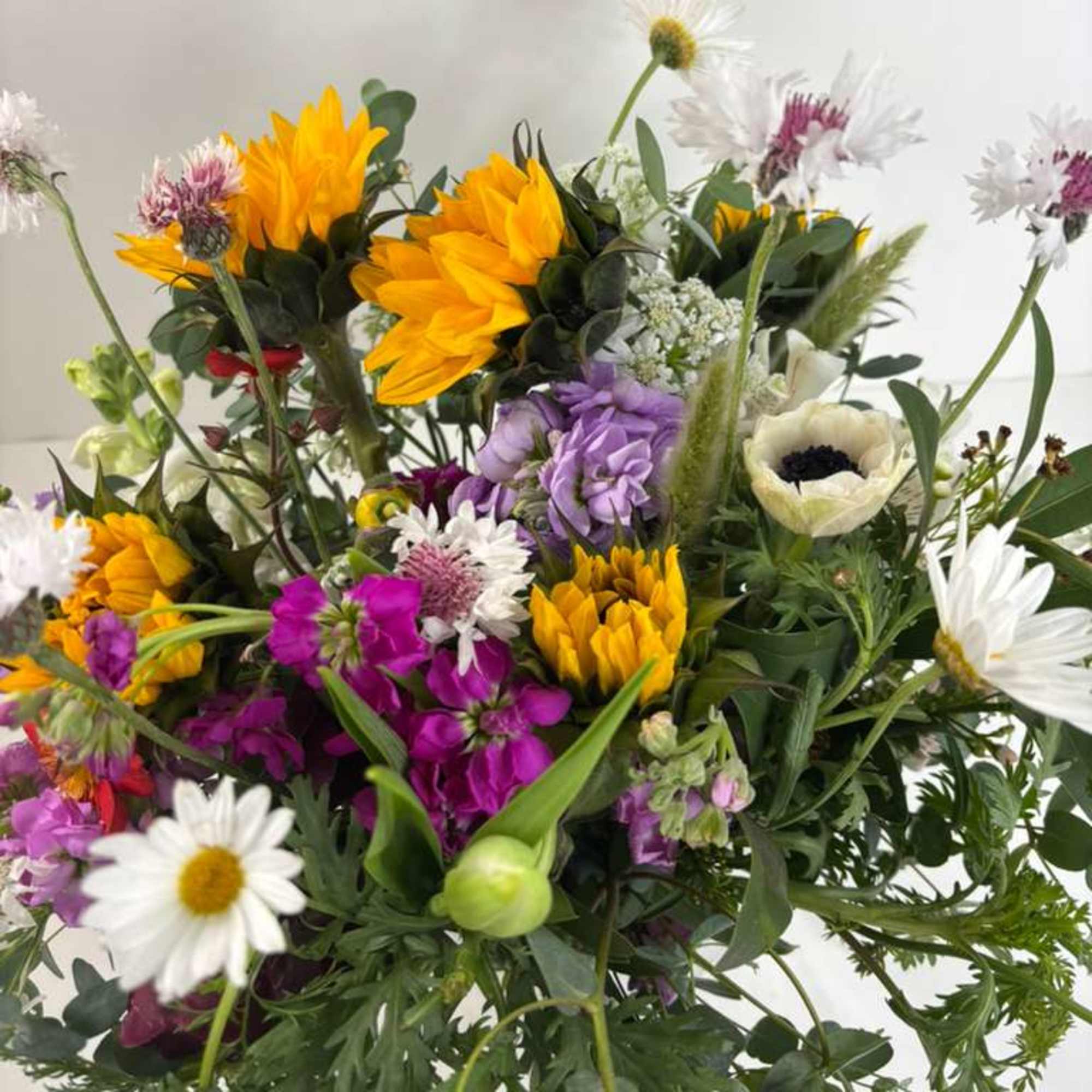 Mixed bouquet with yellow, purple, and white flowers