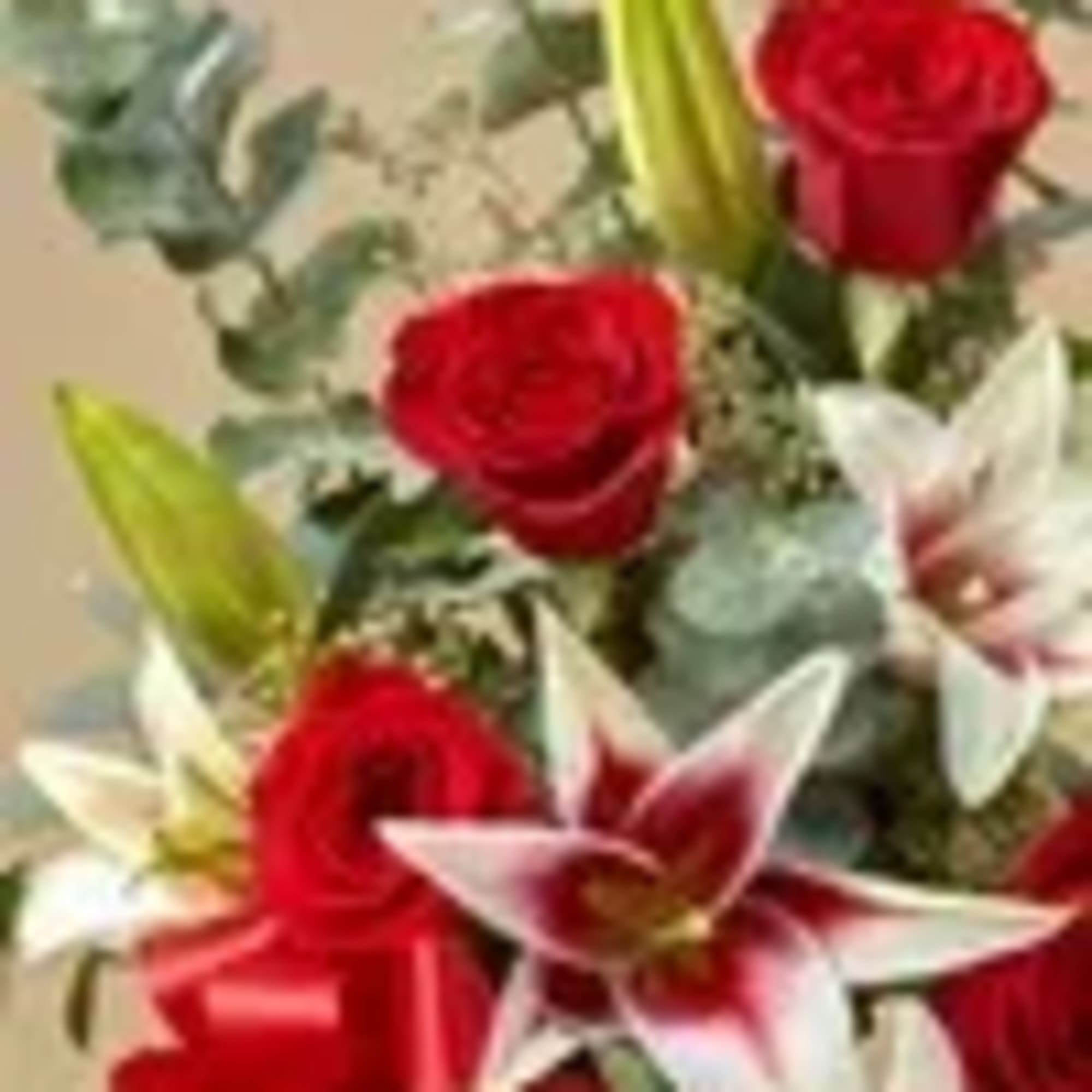 Bouquet of red roses and white lilies with greenery