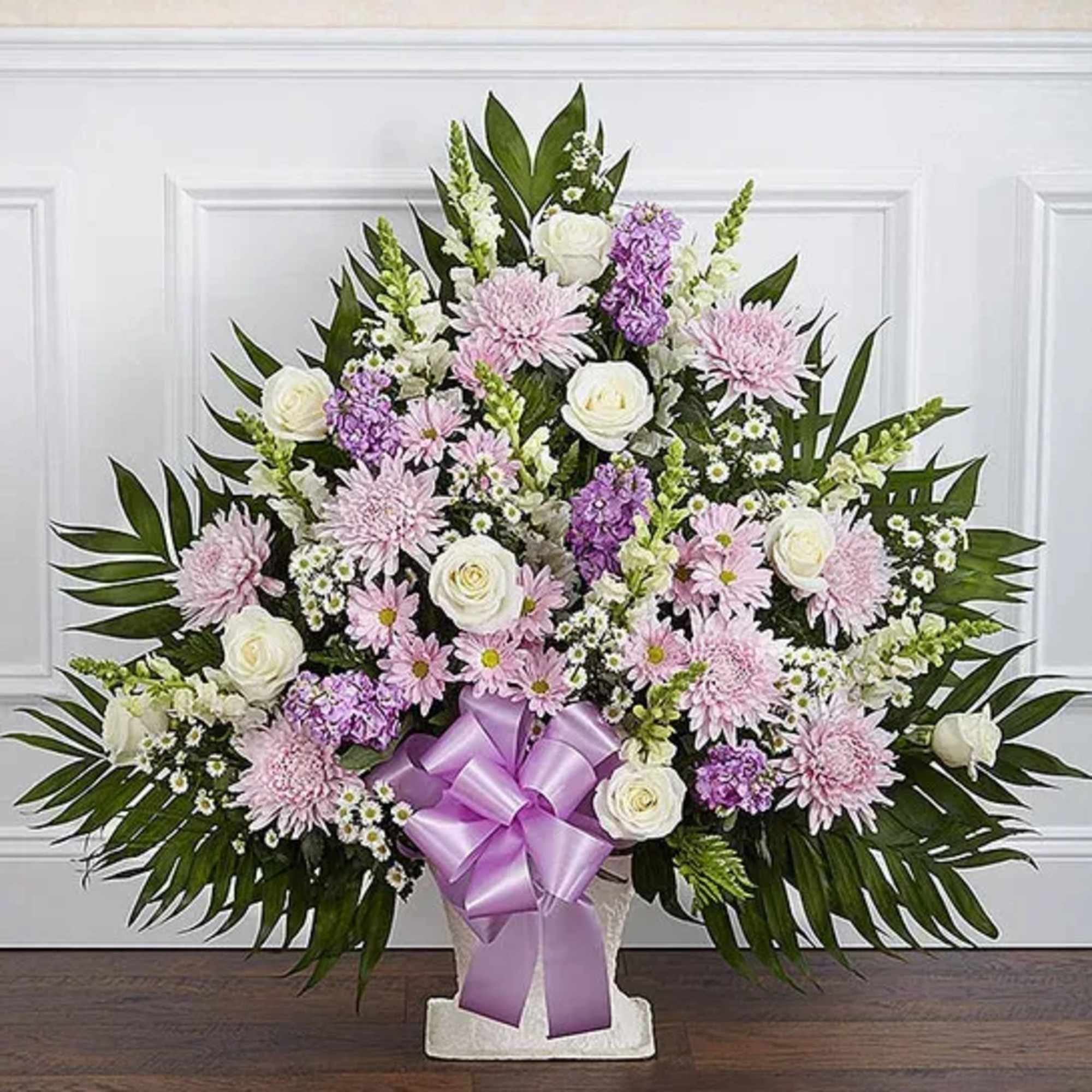 Large standing floral spray with pink and white blooms and a lavender ribbon