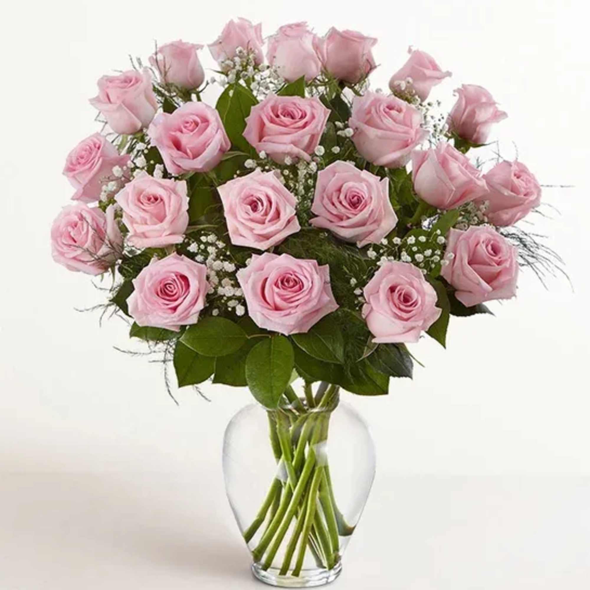Pink roses arranged in a clear glass vase
