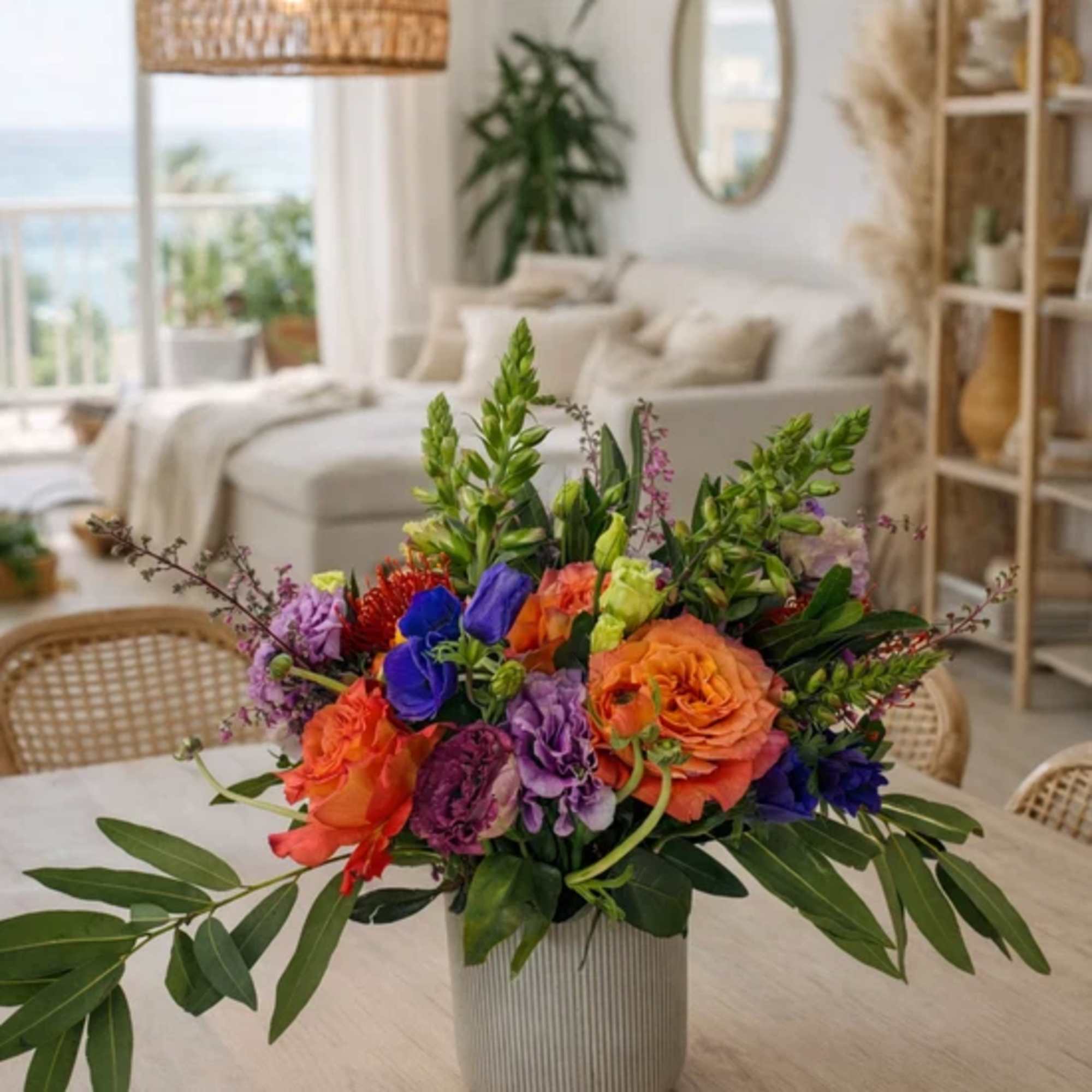 Colorful mixed flower arrangement in a ribbed vase on a table
