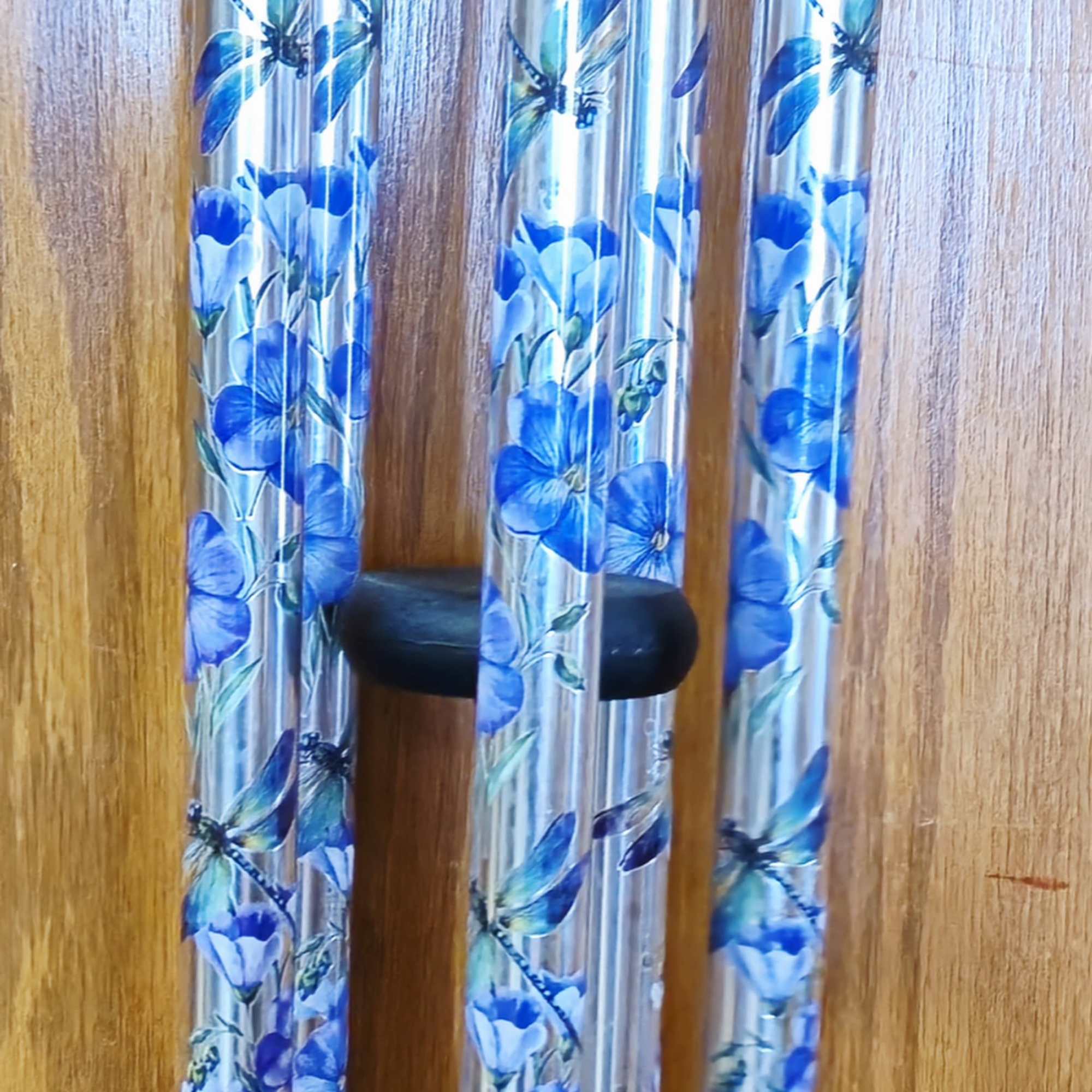 A luminous dragonfly motif and cool blue-and-purple palette make this decorative wind