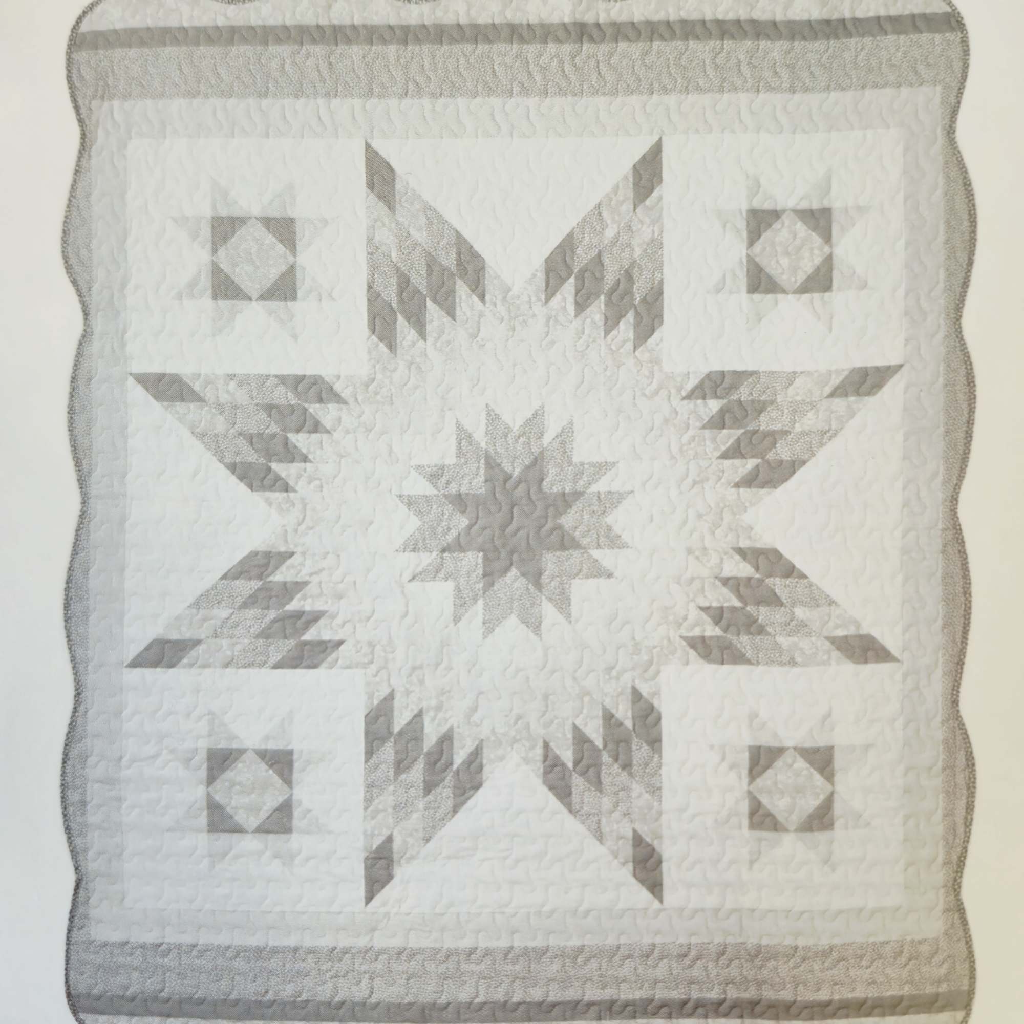 A soft gray-and-white star quilted throw brings quiet comfort to any home