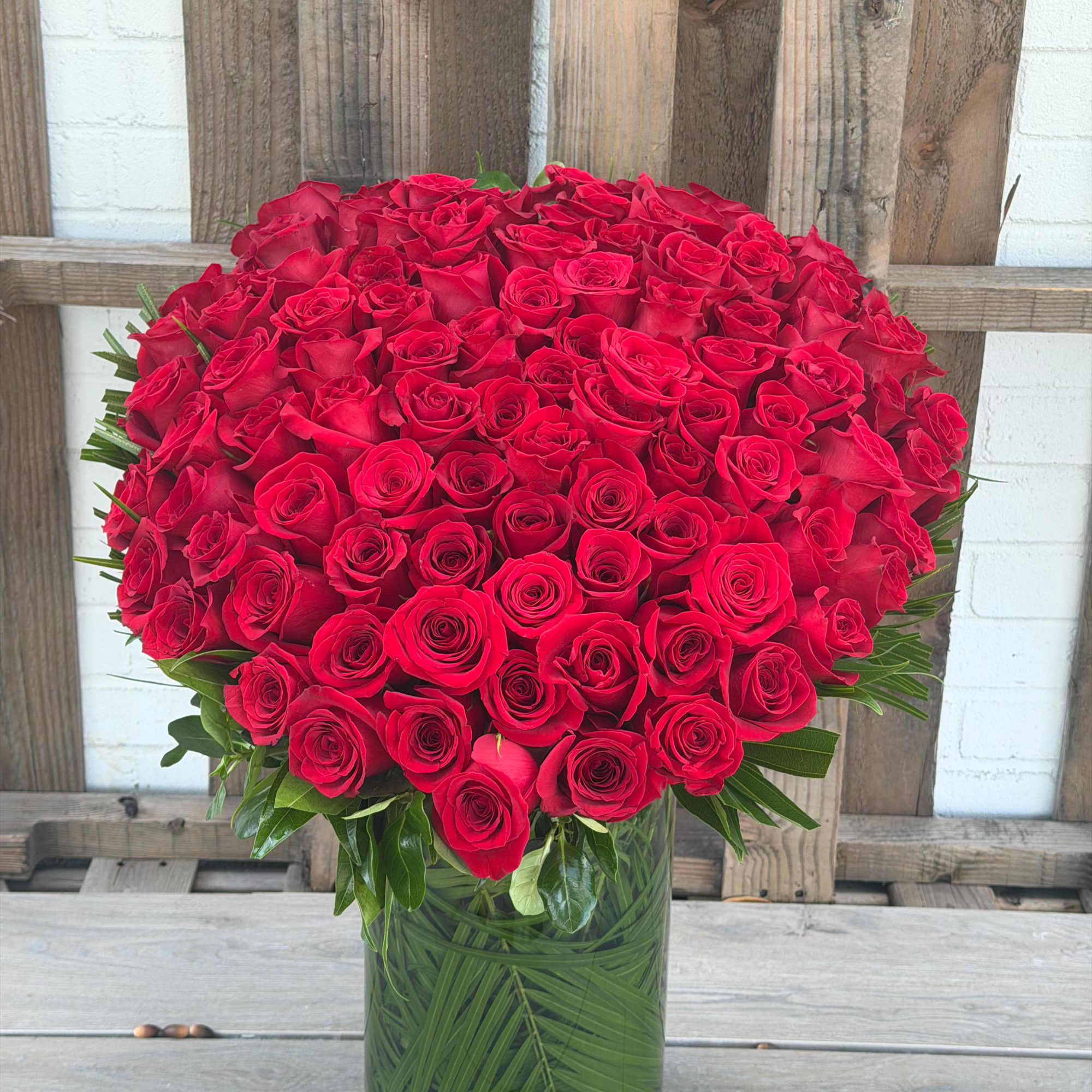 Large bouquet of red roses in a glass vase
