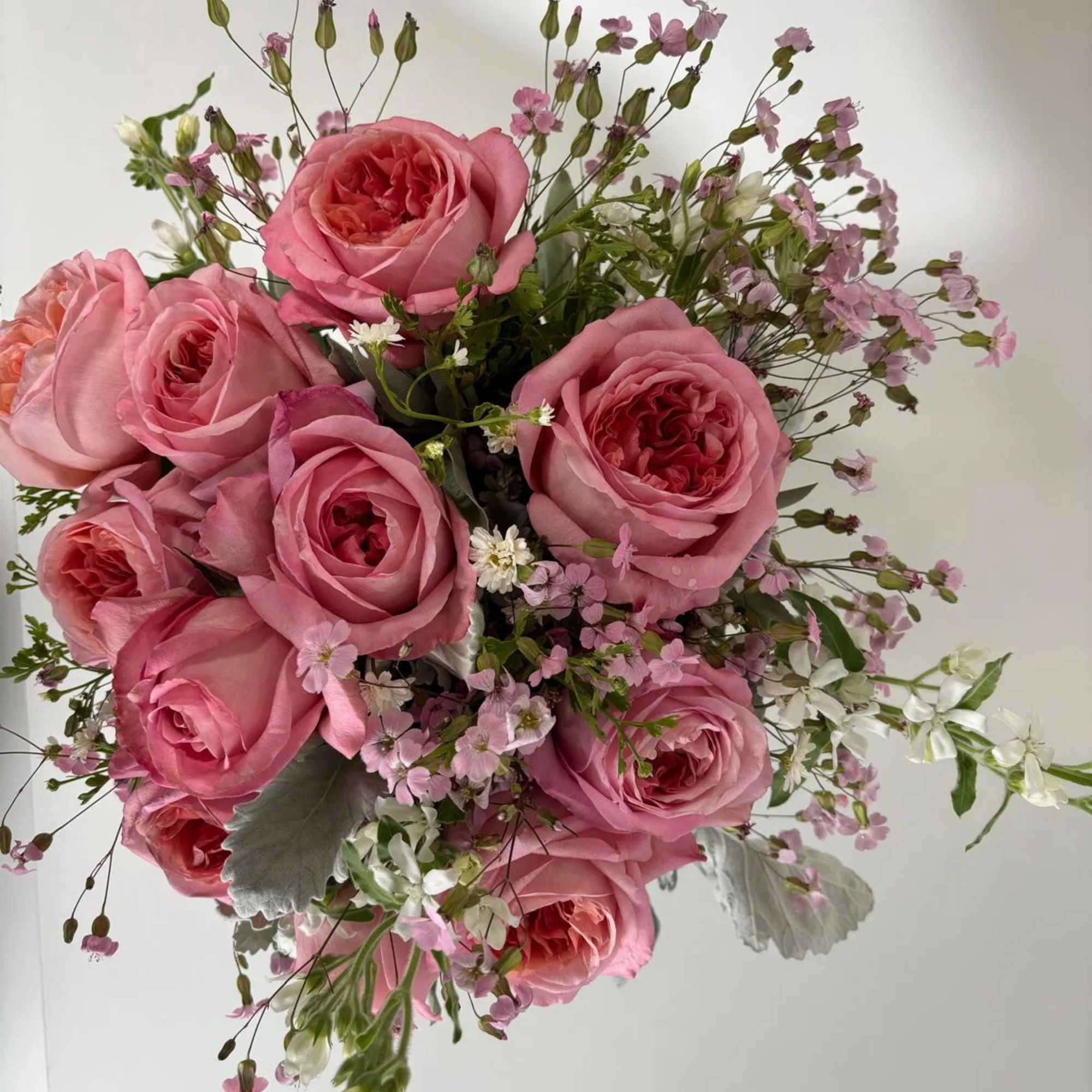 Pink rose bouquet with small white and pink filler flowers